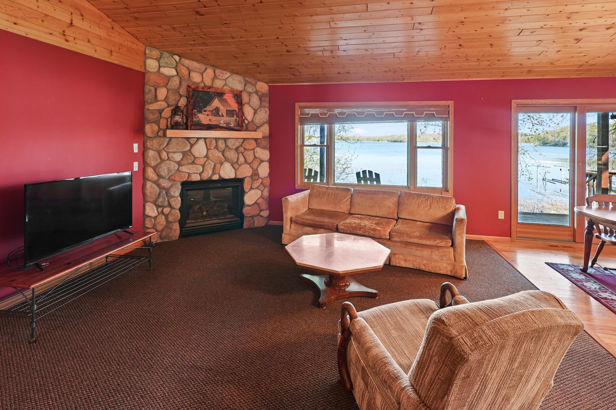 Beautiful stone gas burning corner fireplace.