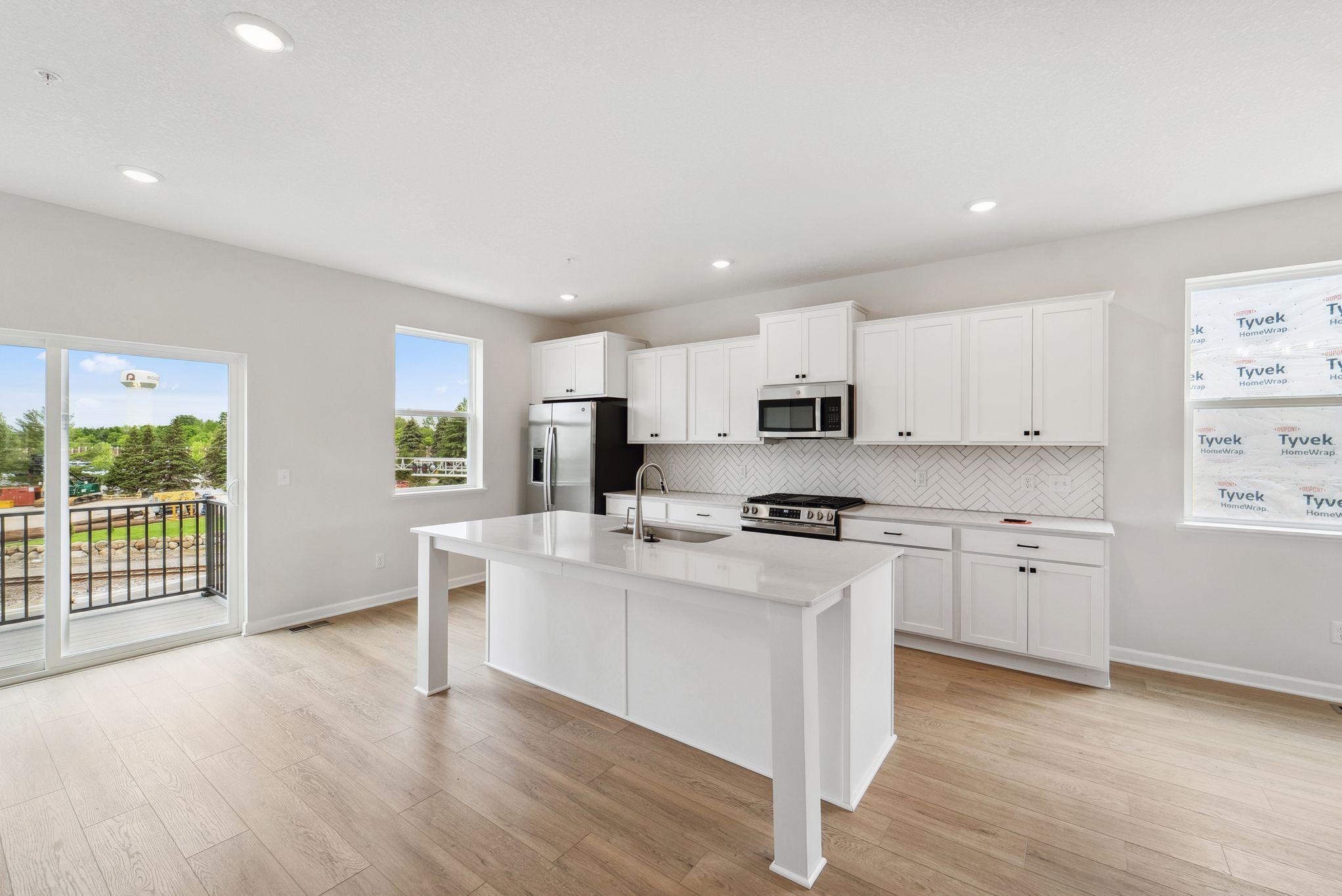 A large center island offers the prefect blend for cooking, hosting friends and family, and extra prep space