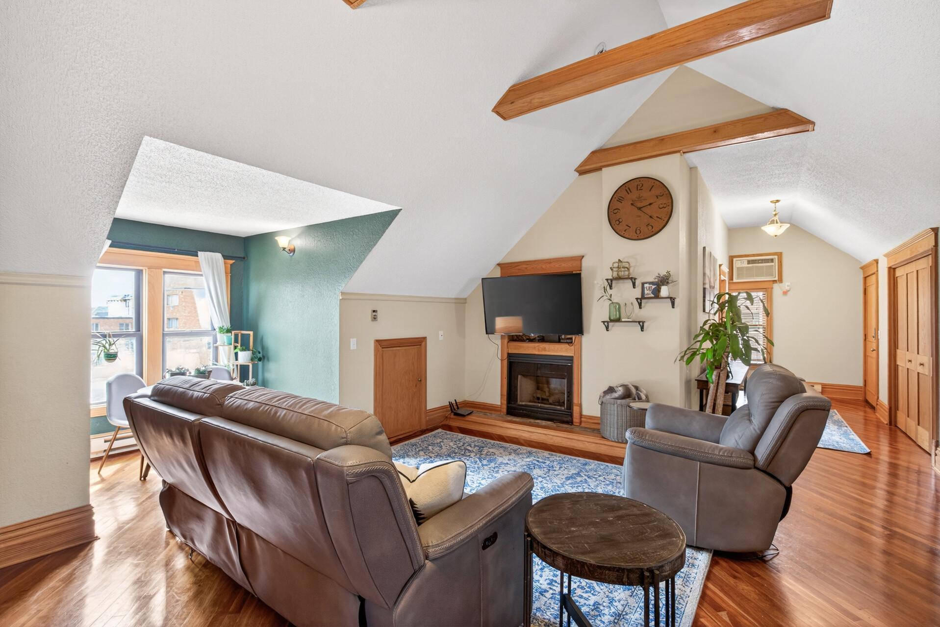 Enjoy soaring vaulted ceilings with wood beams for an open and airy feel!