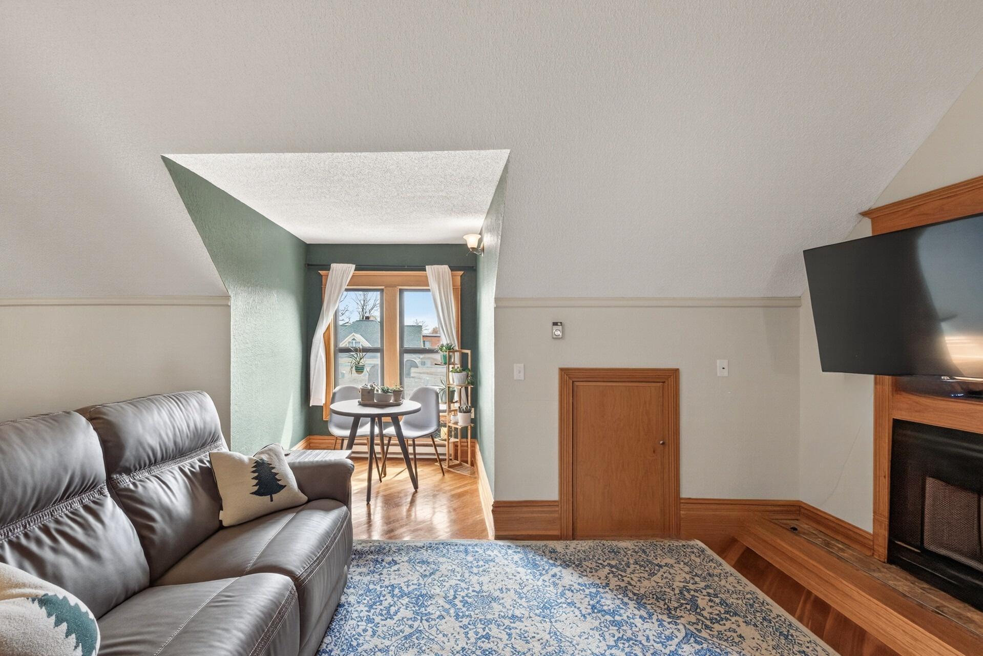 The living room is centered around a gas fireplace adding warmth and a cozy ambiance.