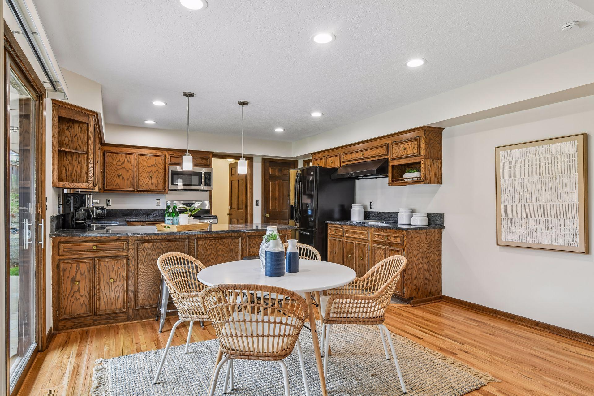19x13 Upper Level Kitchen with eat-in casual dining area with freshly refinished oak hardwood floors, Granite counter tops, and fresh paint. West-facing windows