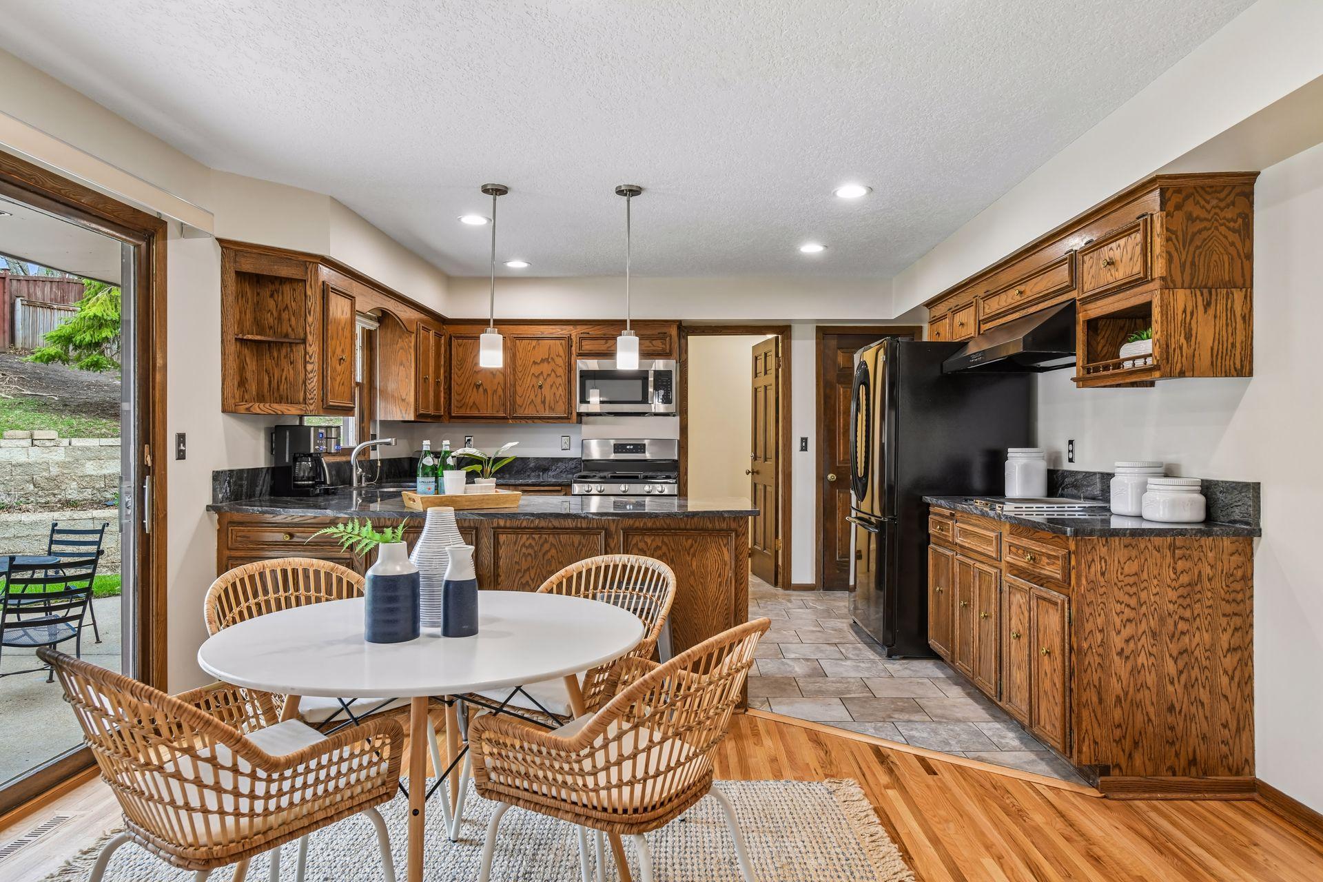 19x13 Upper Level Kitchen with eat-in casual dining area with freshly refinished oak hardwood floors, Granite counter tops, and fresh paint. West-facing windows