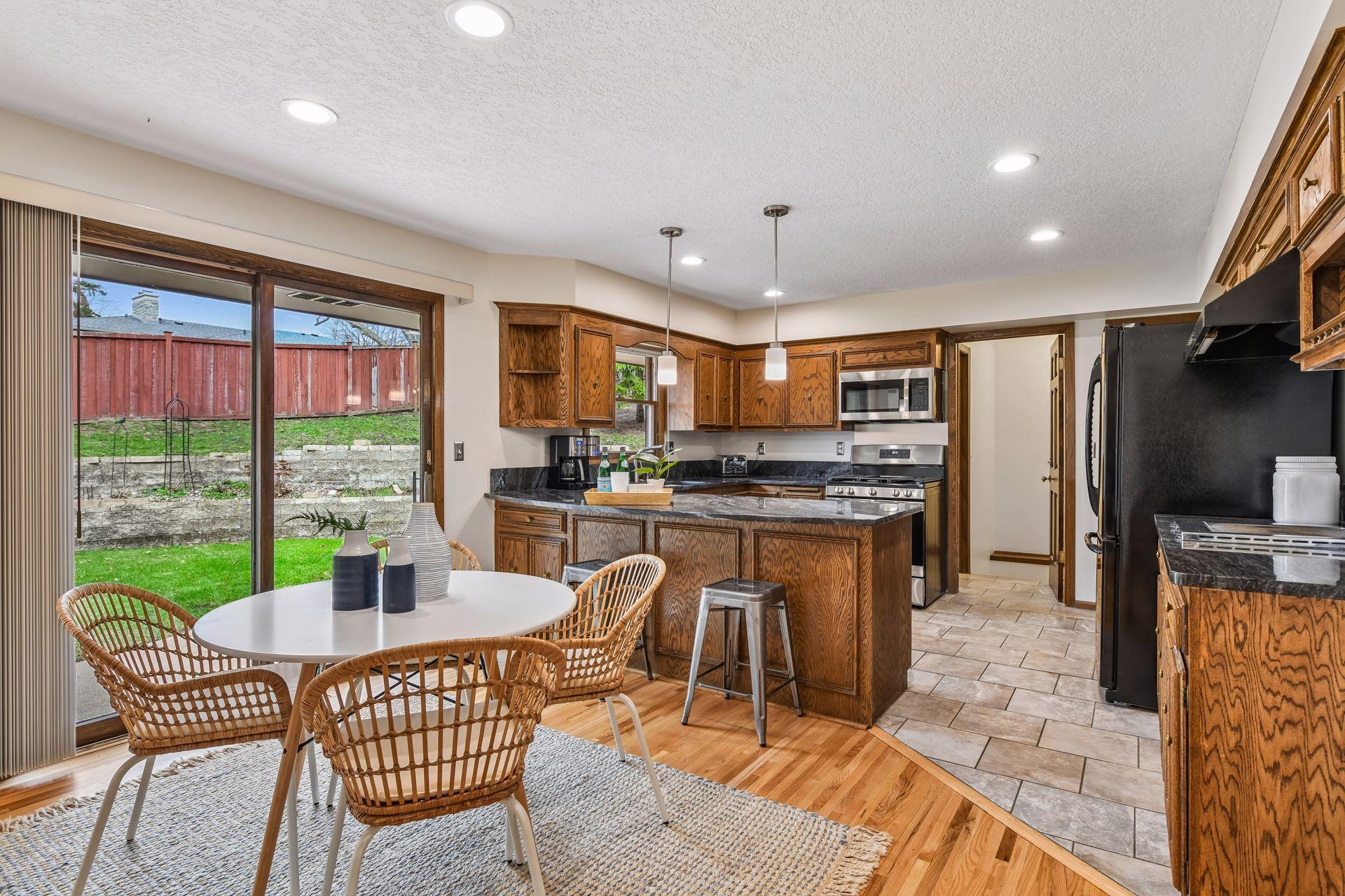 19x13 Upper Level Kitchen with eat-in casual dining area with freshly refinished oak hardwood floors, Granite counter tops, and fresh paint. West-facing windows