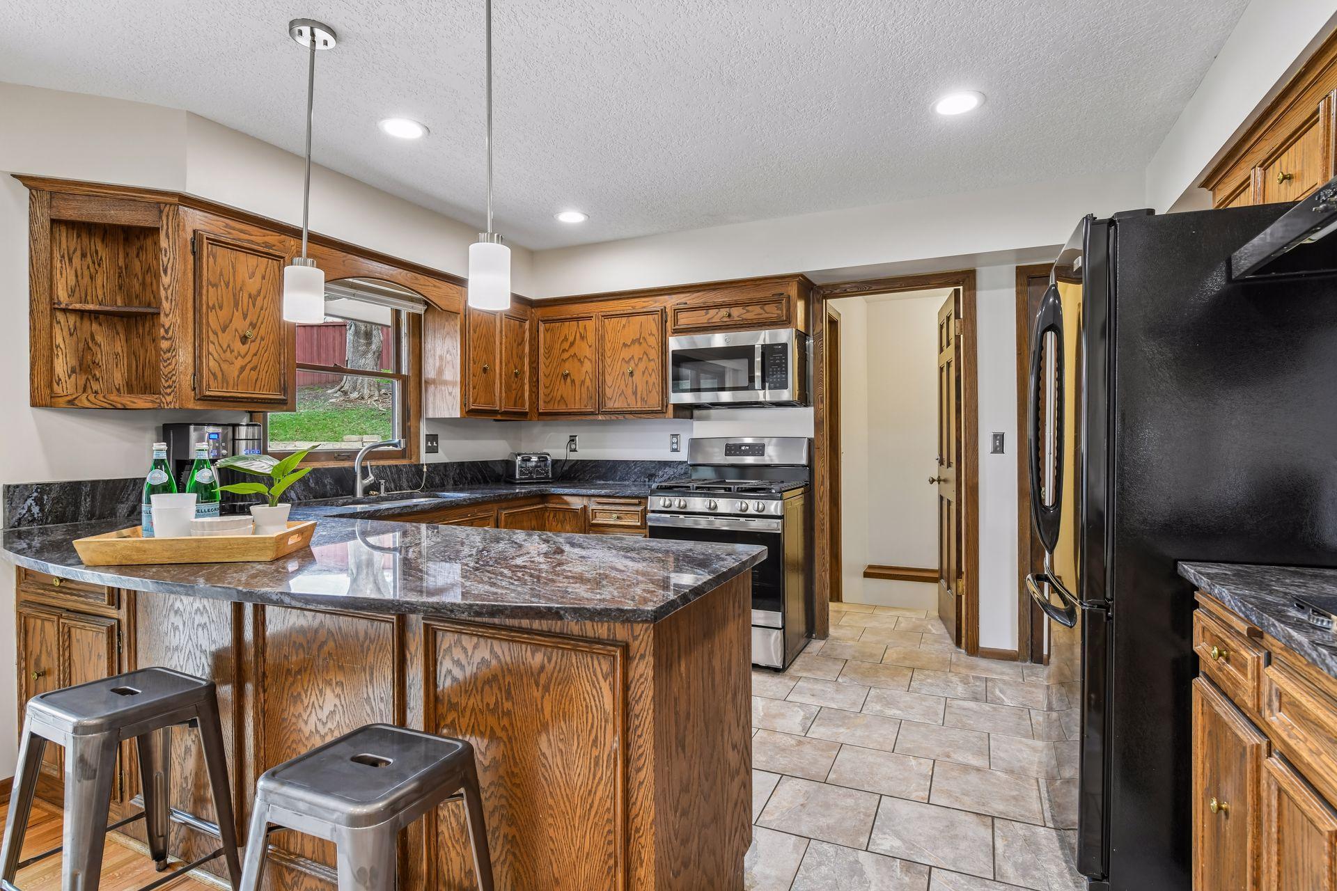 19x13 Upper Level Kitchen with eat-in casual dining area with freshly refinished oak hardwood floors, Granite counter tops, and fresh paint. West-facing windows