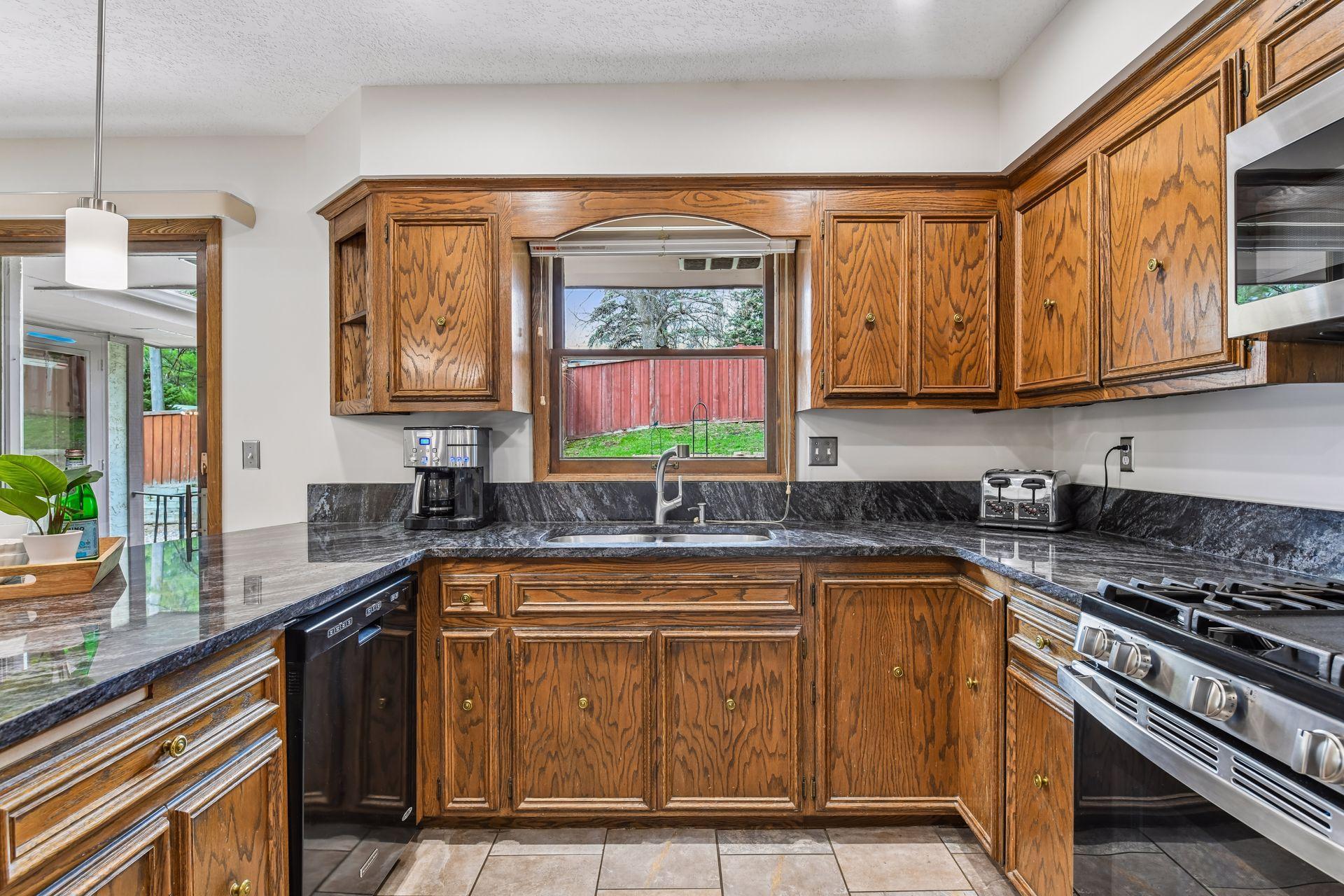 19x13 Upper Level Kitchen with eat-in casual dining area with freshly refinished oak hardwood floors, Granite counter tops, and fresh paint. West-facing windows