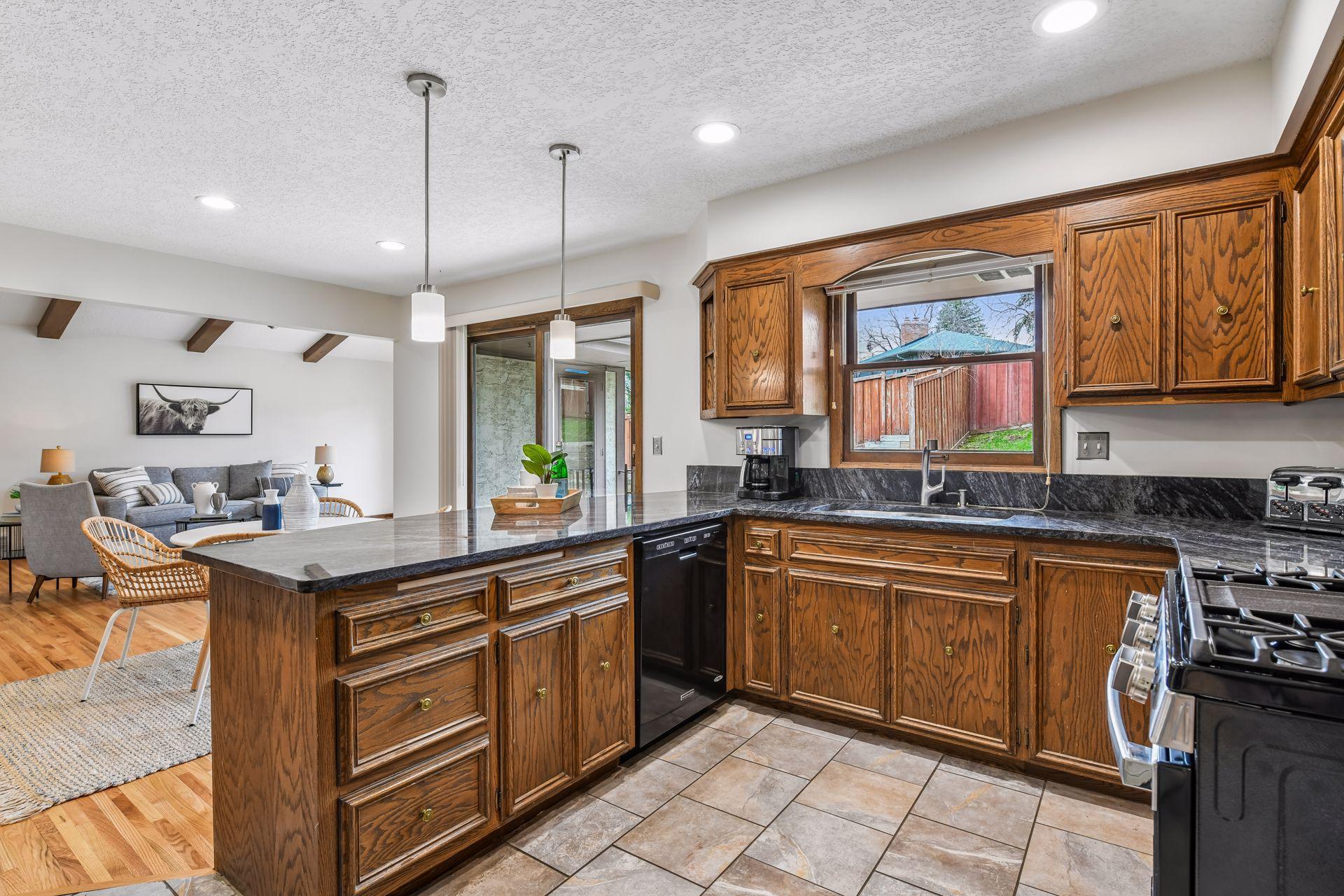 19x13 Upper Level Kitchen with eat-in casual dining area with freshly refinished oak hardwood floors, Granite counter tops, and fresh paint. West-facing windows