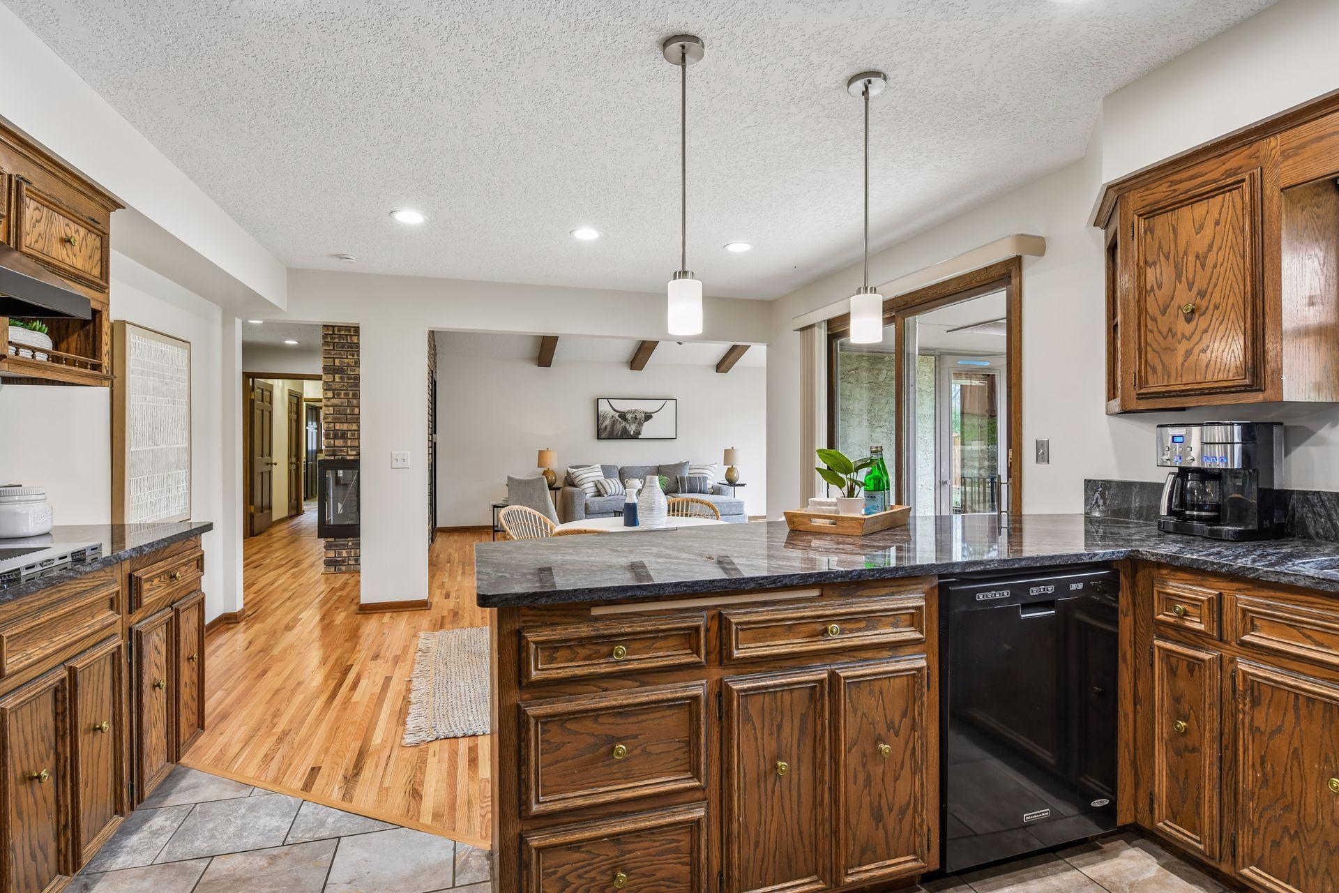 19x13 Upper Level Kitchen with eat-in casual dining area with freshly refinished oak hardwood floors, Granite counter tops, and fresh paint. West-facing windows