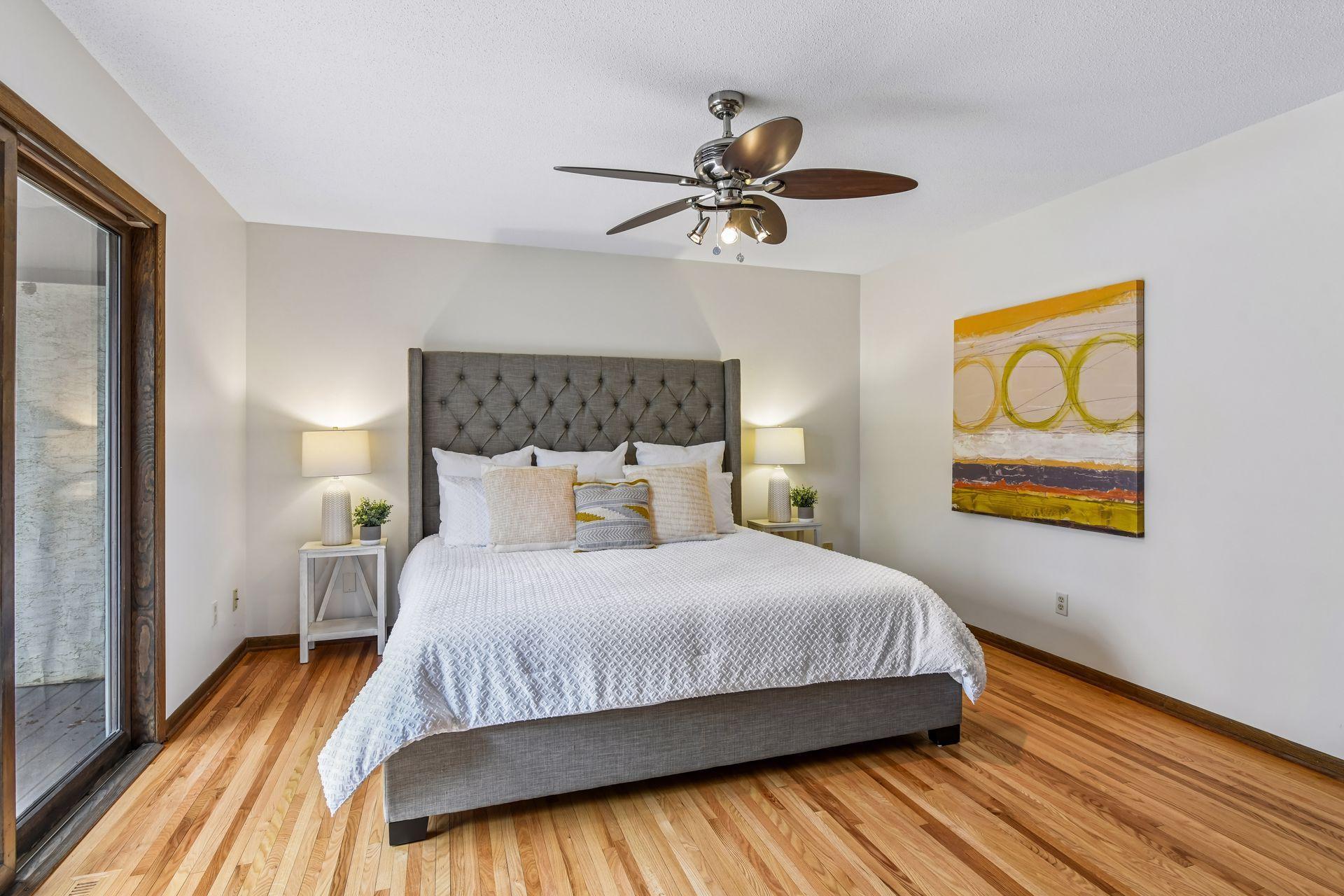 14x13 Upper Level Primary Bedroom with an en-suite 3/4 bathroom. Newly refinished oak hardwood floors and fresh paint. West-facing sliding glass windows open to a private west-facing deck.