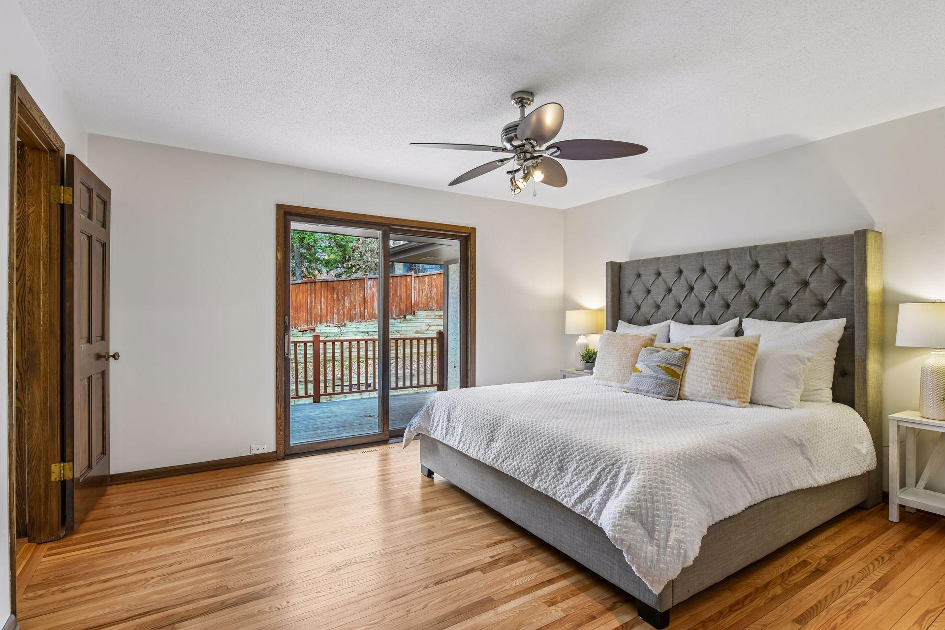 14x13 Upper Level Primary Bedroom with an en-suite 3/4 bathroom. Newly refinished oak hardwood floors and fresh paint. West-facing sliding glass windows open to a private west-facing deck.