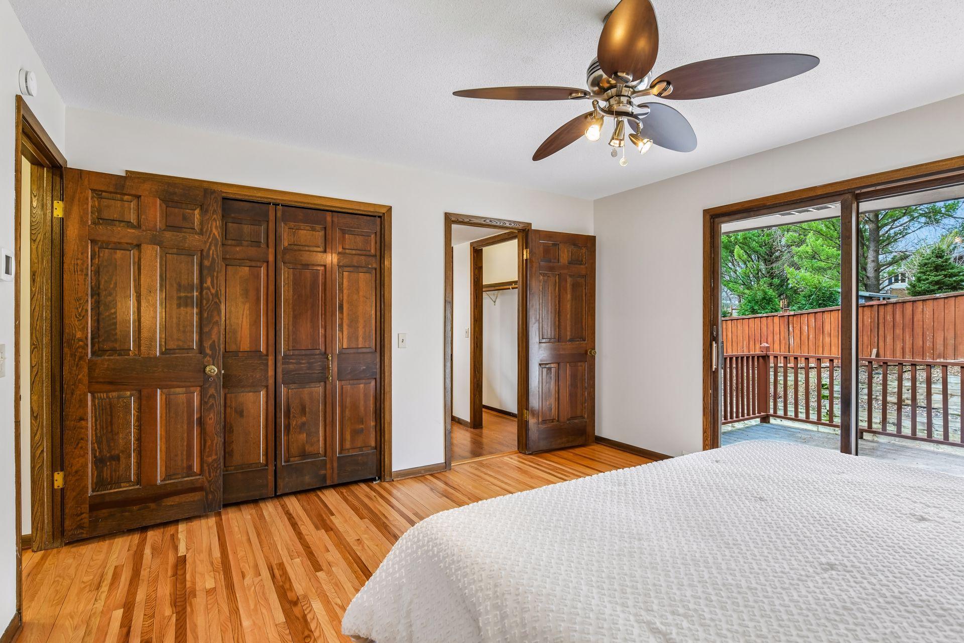 14x13 Upper Level Primary Bedroom with an en-suite 3/4 bathroom. Newly refinished oak hardwood floors and fresh paint. West-facing sliding glass windows open to a private west-facing deck.