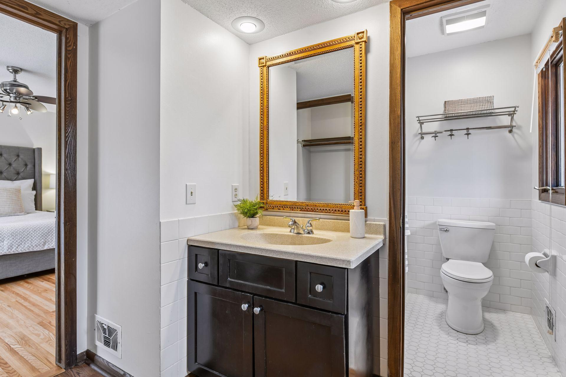 14x13 Upper Level Primary Bedroom with an en-suite 3/4 bathroom. Newly refinished oak hardwood floors and fresh paint. West-facing sliding glass windows open to a private west-facing deck.