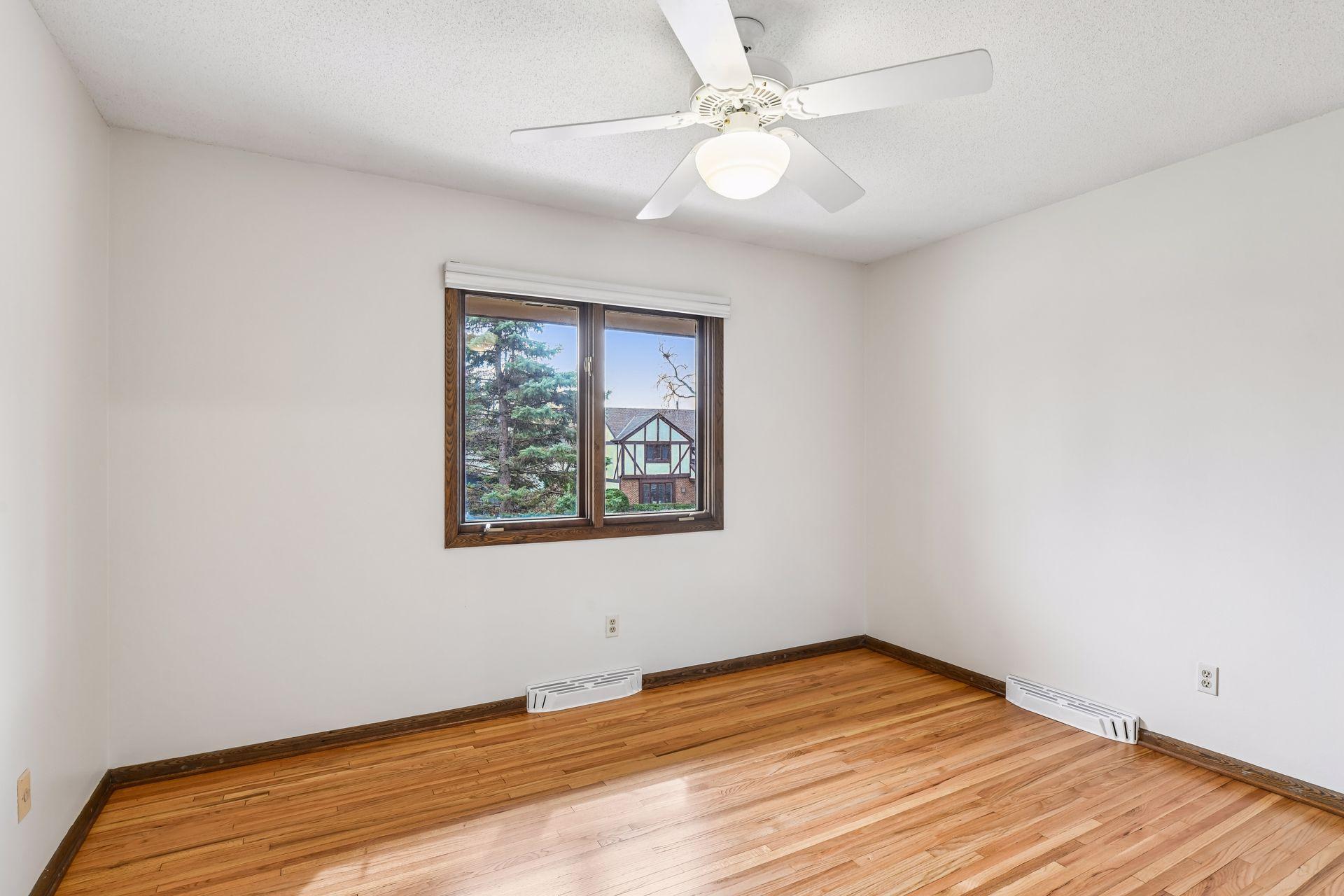12x10 Upper Bedroom #2 with newly refinished oak hardwood floors and fresh paint. East-facing windows.