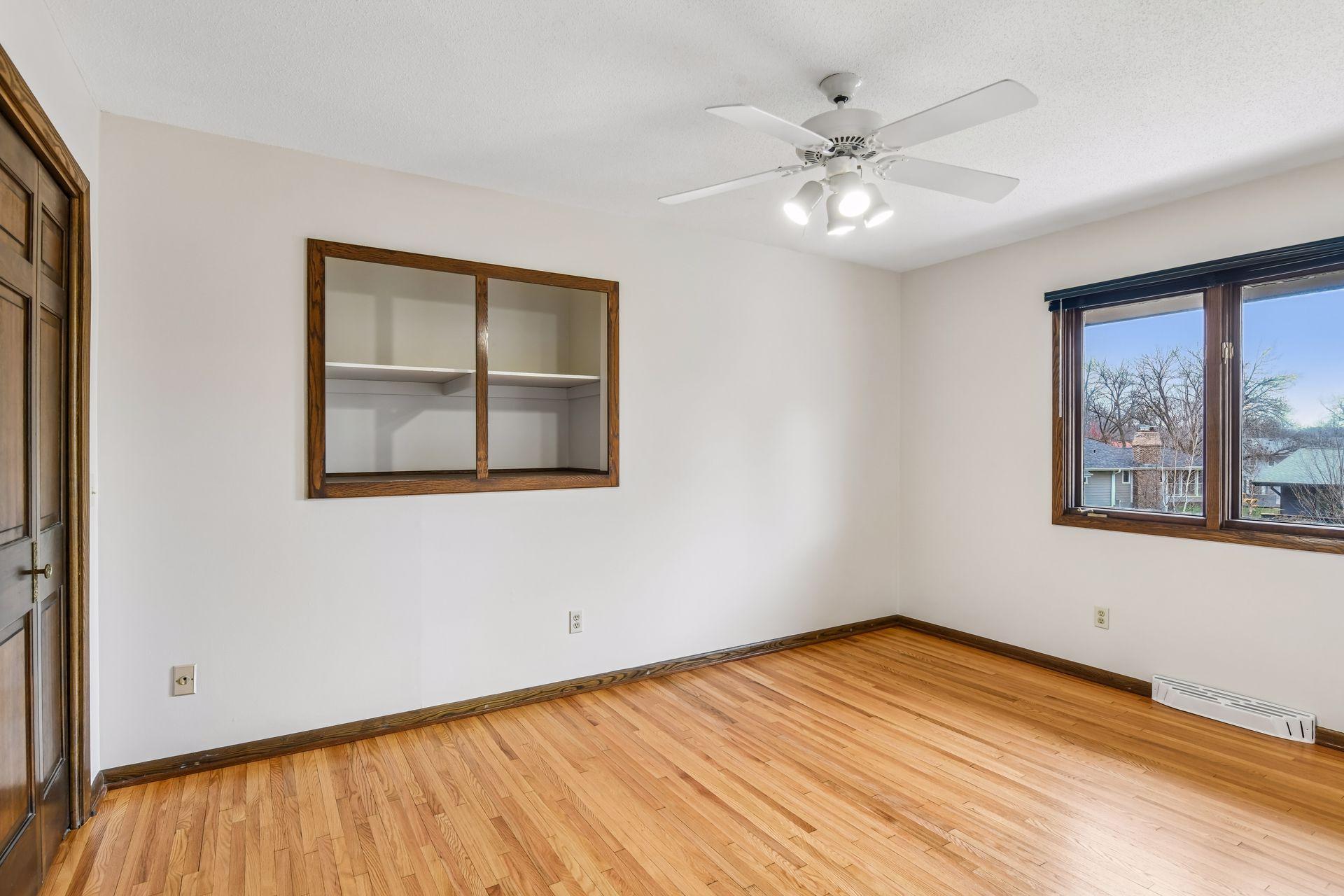 14x10 Upper Bedroom #3 with newly refinished oak hardwood floors and fresh paint. East-facing windows.