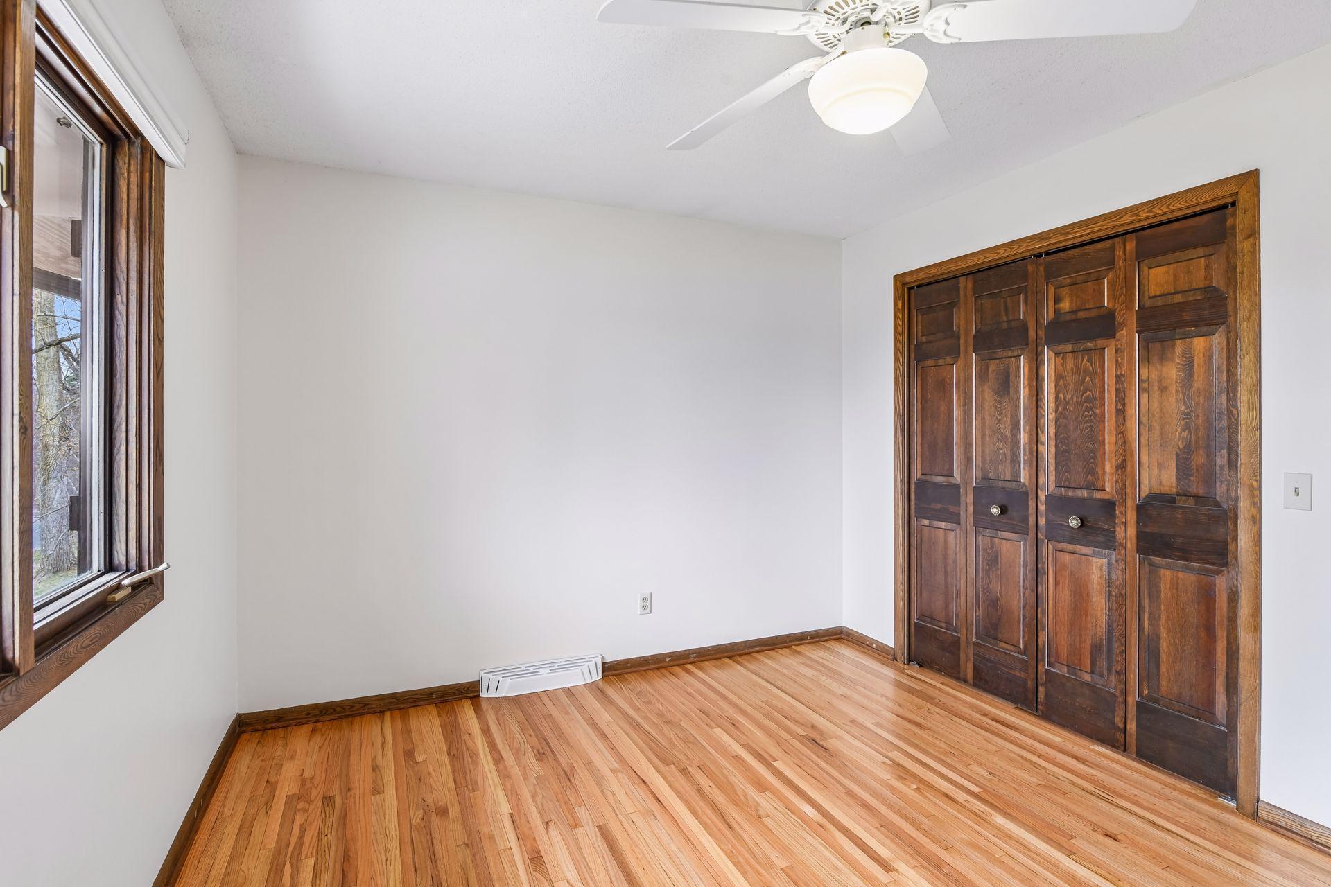 12x10 Upper Bedroom #2 with newly refinished oak hardwood floors and fresh paint. East-facing windows.