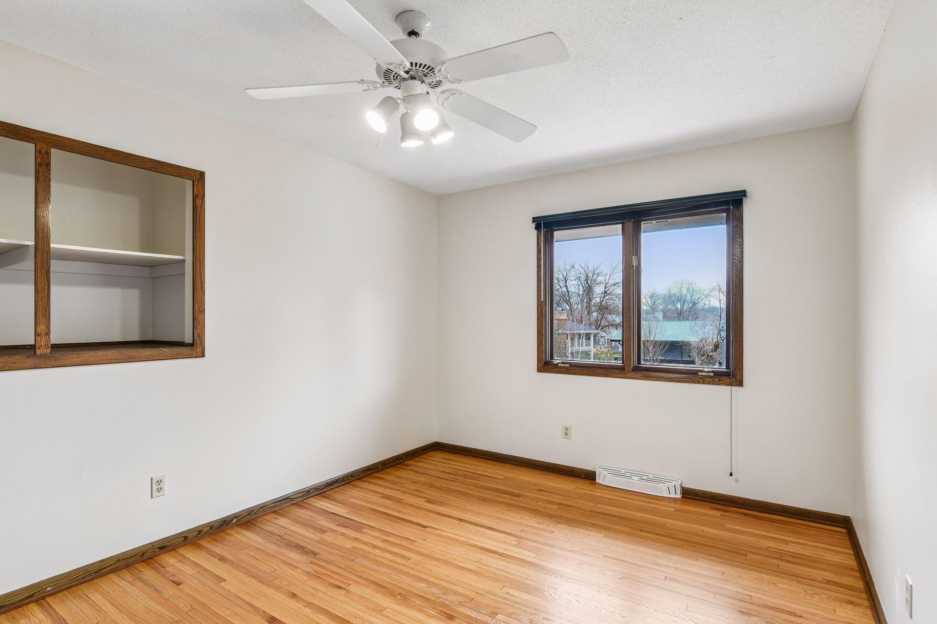 14x10 Upper Bedroom #3 with newly refinished oak hardwood floors and fresh paint. East-facing windows.