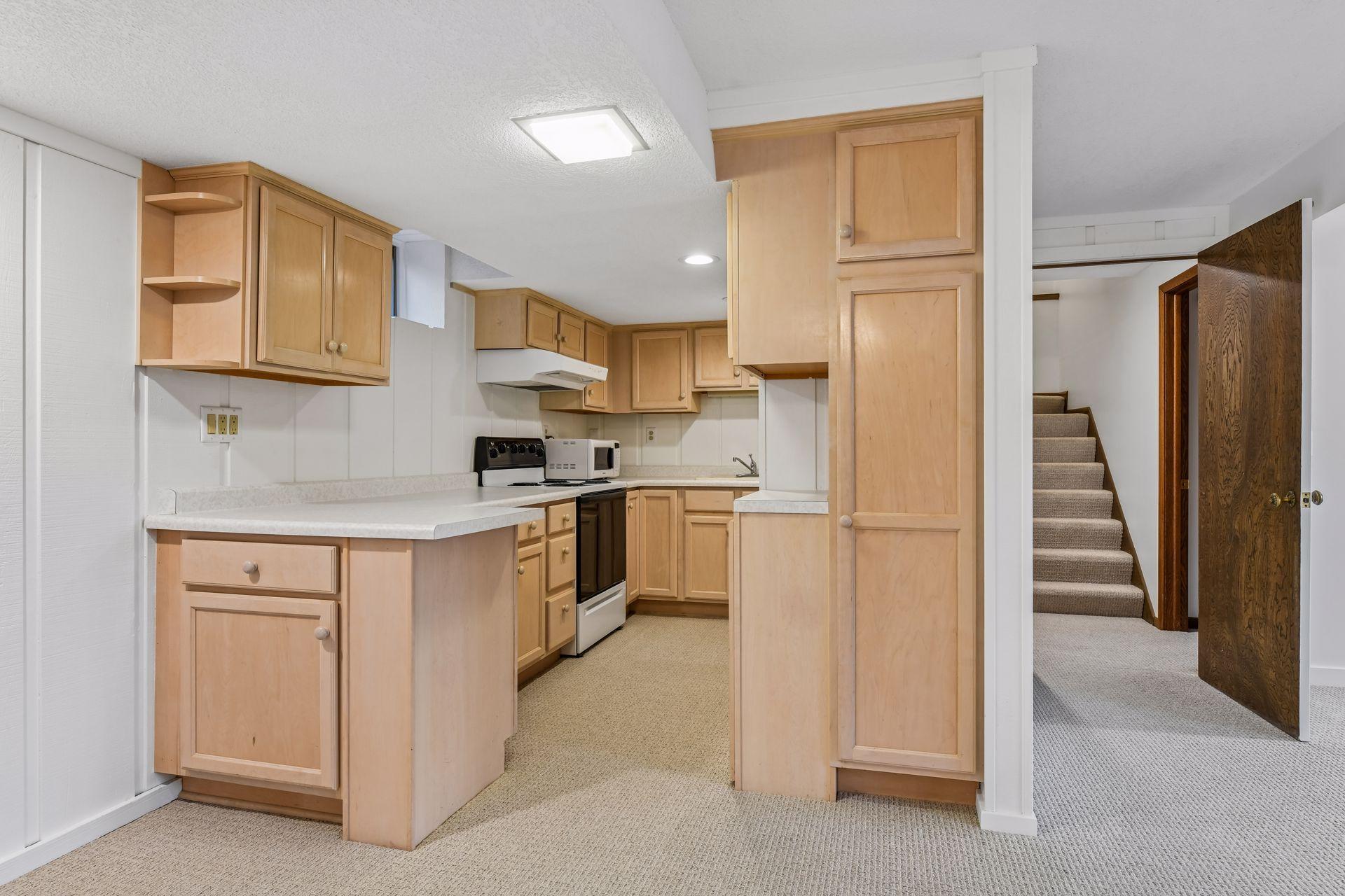 17x9 Lower-Level Wet bar with New carpeting and fresh paint. East-facing windows.