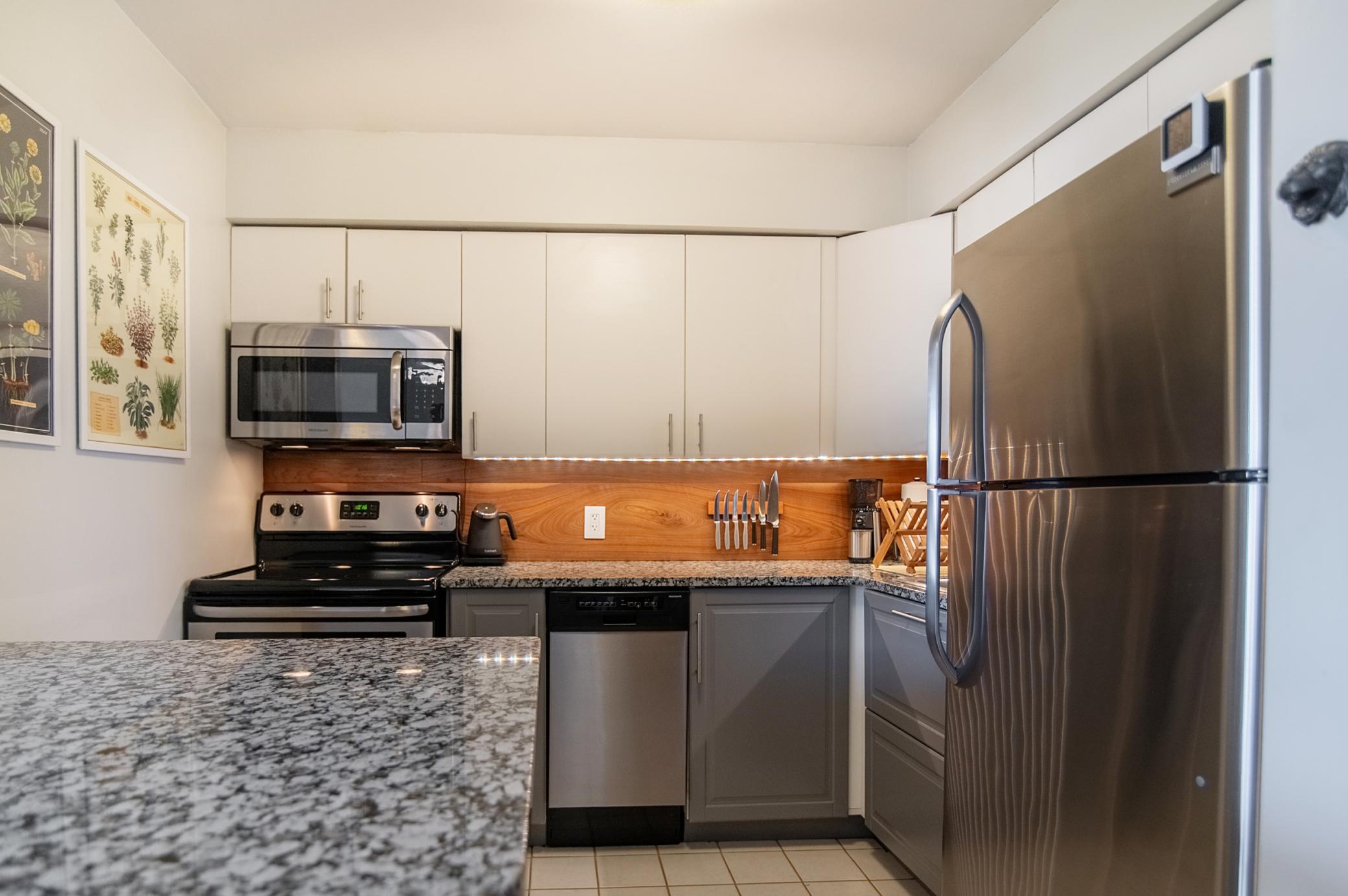 A wood backsplash provides warmth and contrast to the neutral cabinetry allowing you to make this space uniquely yours.