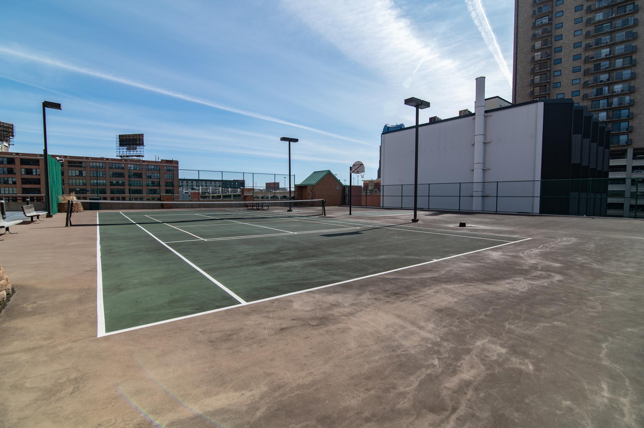 The second floor of the condo building features a wraparound patio as well as Tennis and basketball play surfaces.