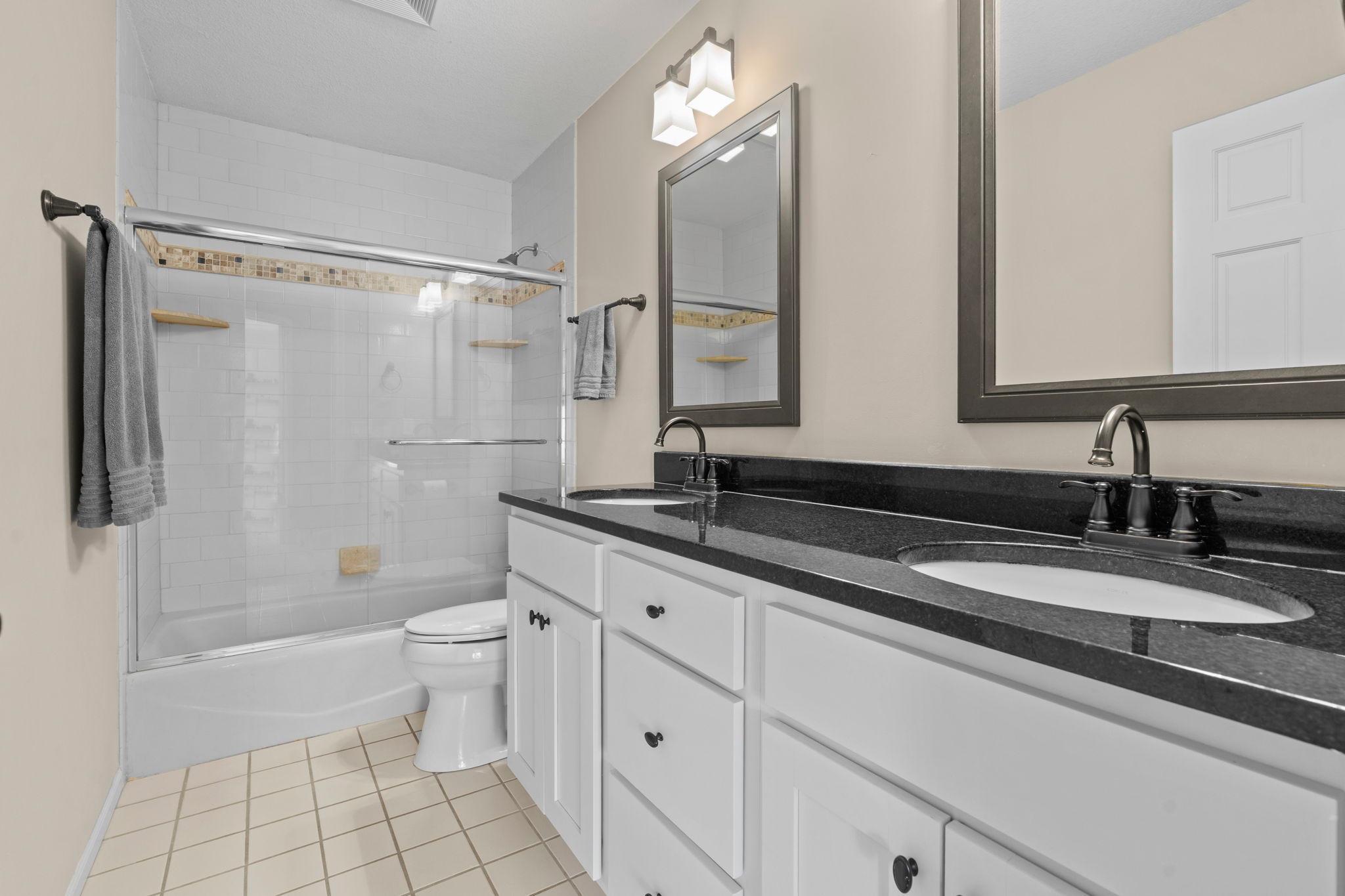 Upper level hallway bathroom with double vanity