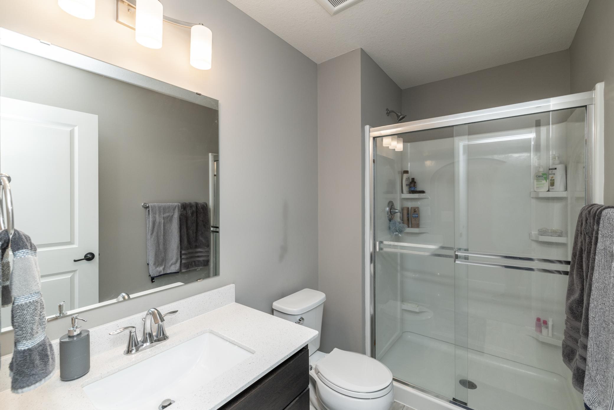 Spacious bedroom featuring an attached private 3/4 bathroom