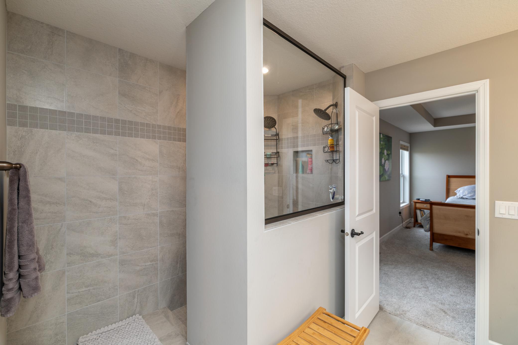 Spa-inspired primary bath with separate shower and elegant finishes