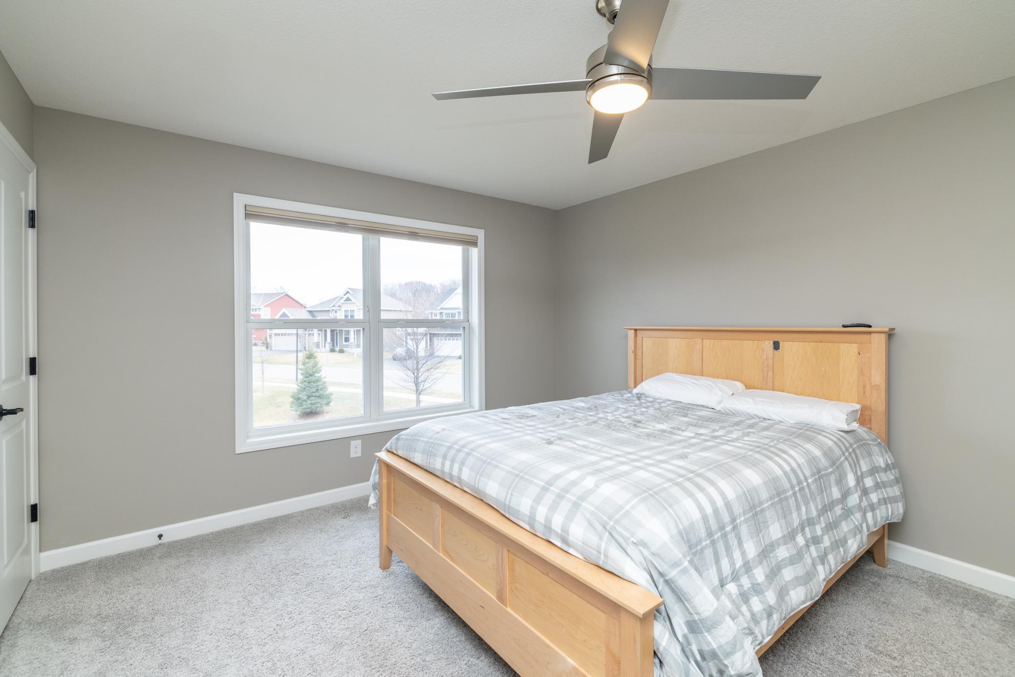 Well-appointed bedroom featuring a large window, serene views, and its own private 3/4 bathroom