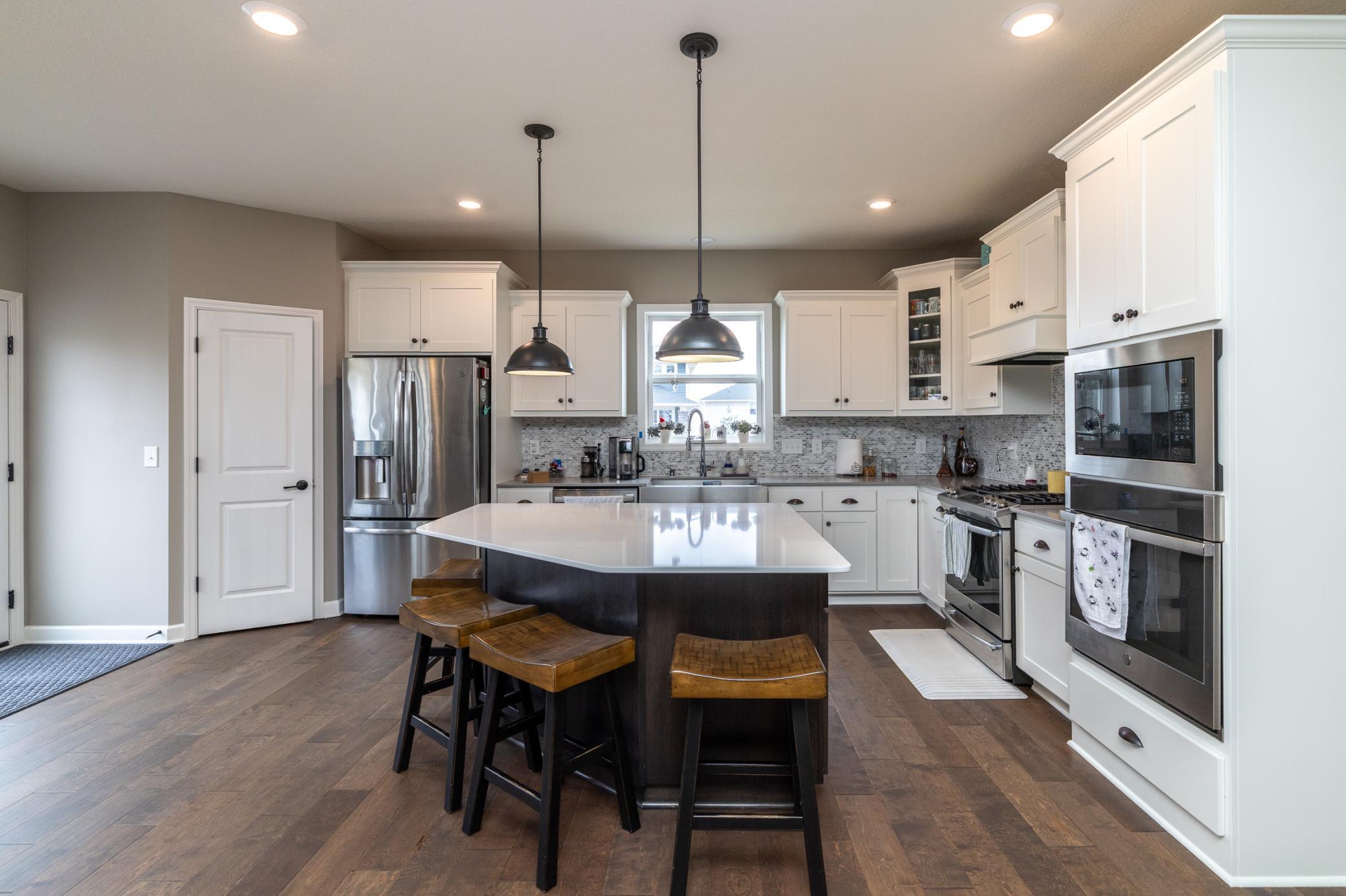 Gourmet kitchen with oversized center island and stainless steel appliances