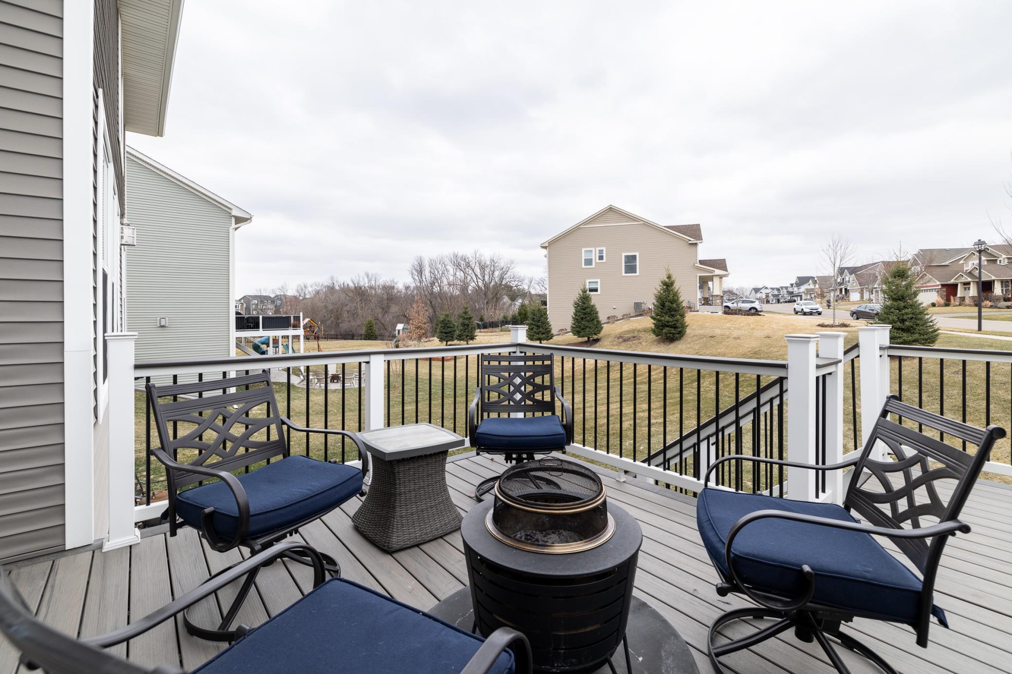 Elevated deck with plenty of space to gather and enjoy backyard views