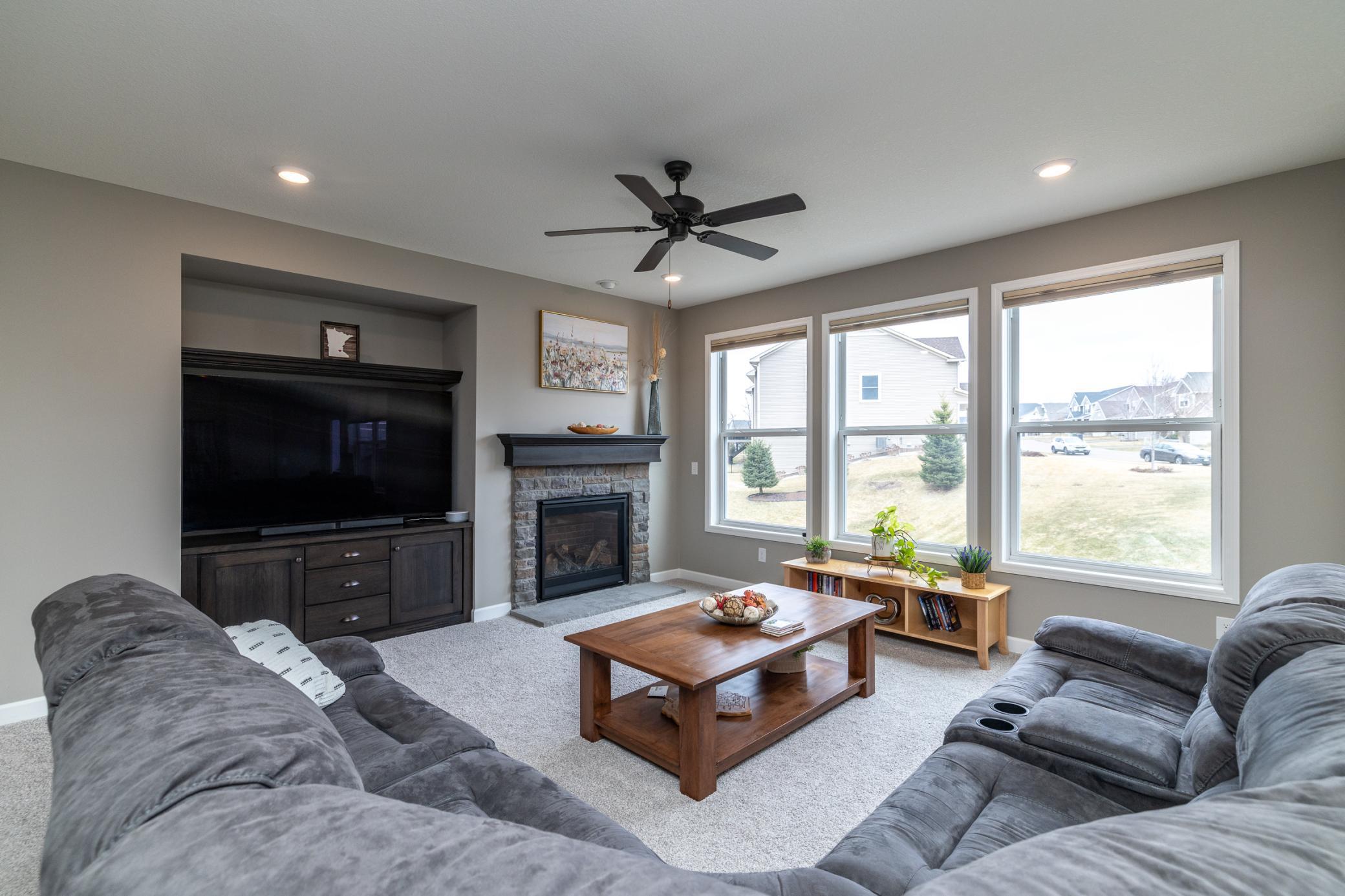 Cozy family room with fireplace and large windows overlooking the yard