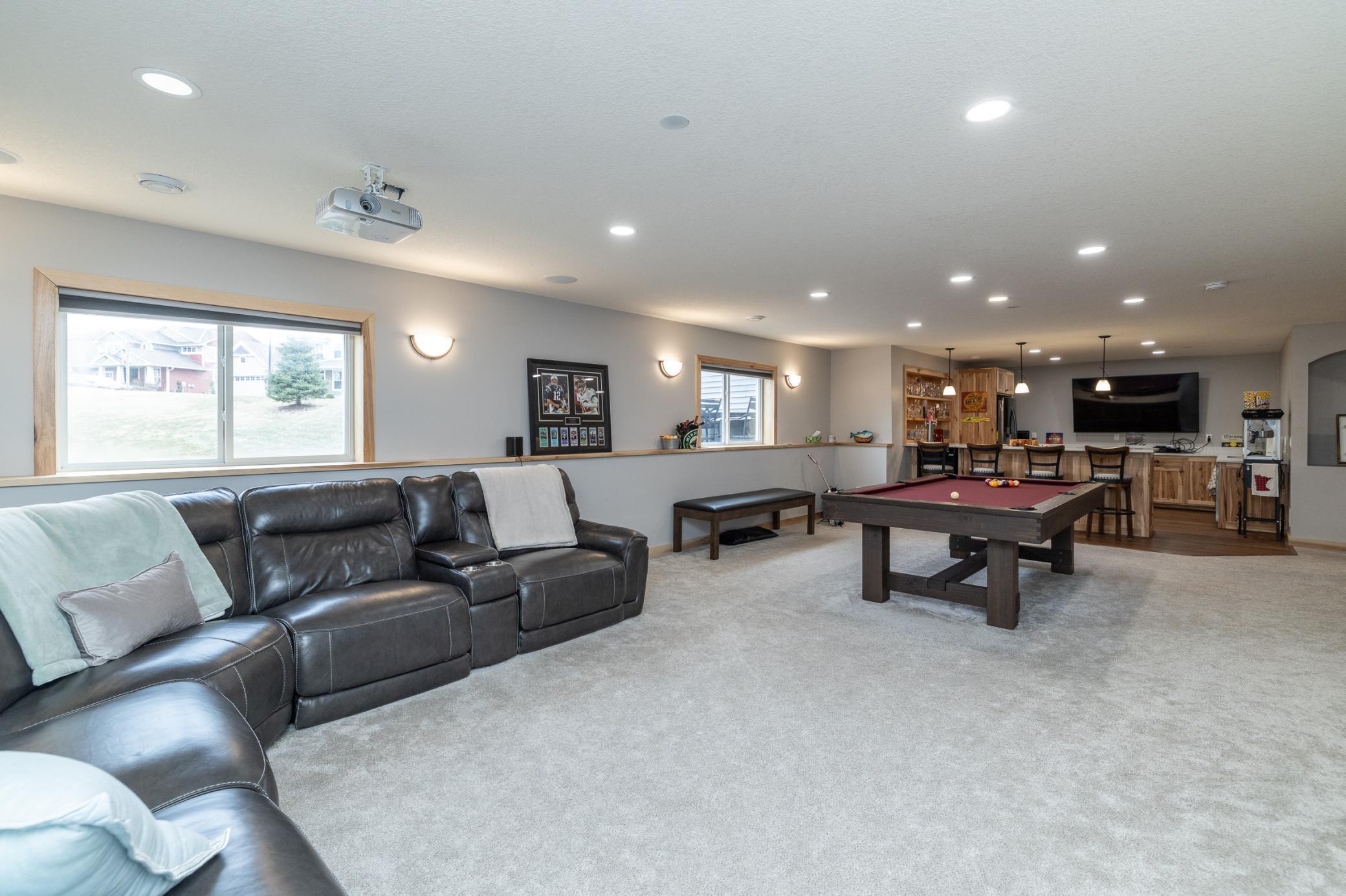 Large lower-level family room with multiple entertaining spaces