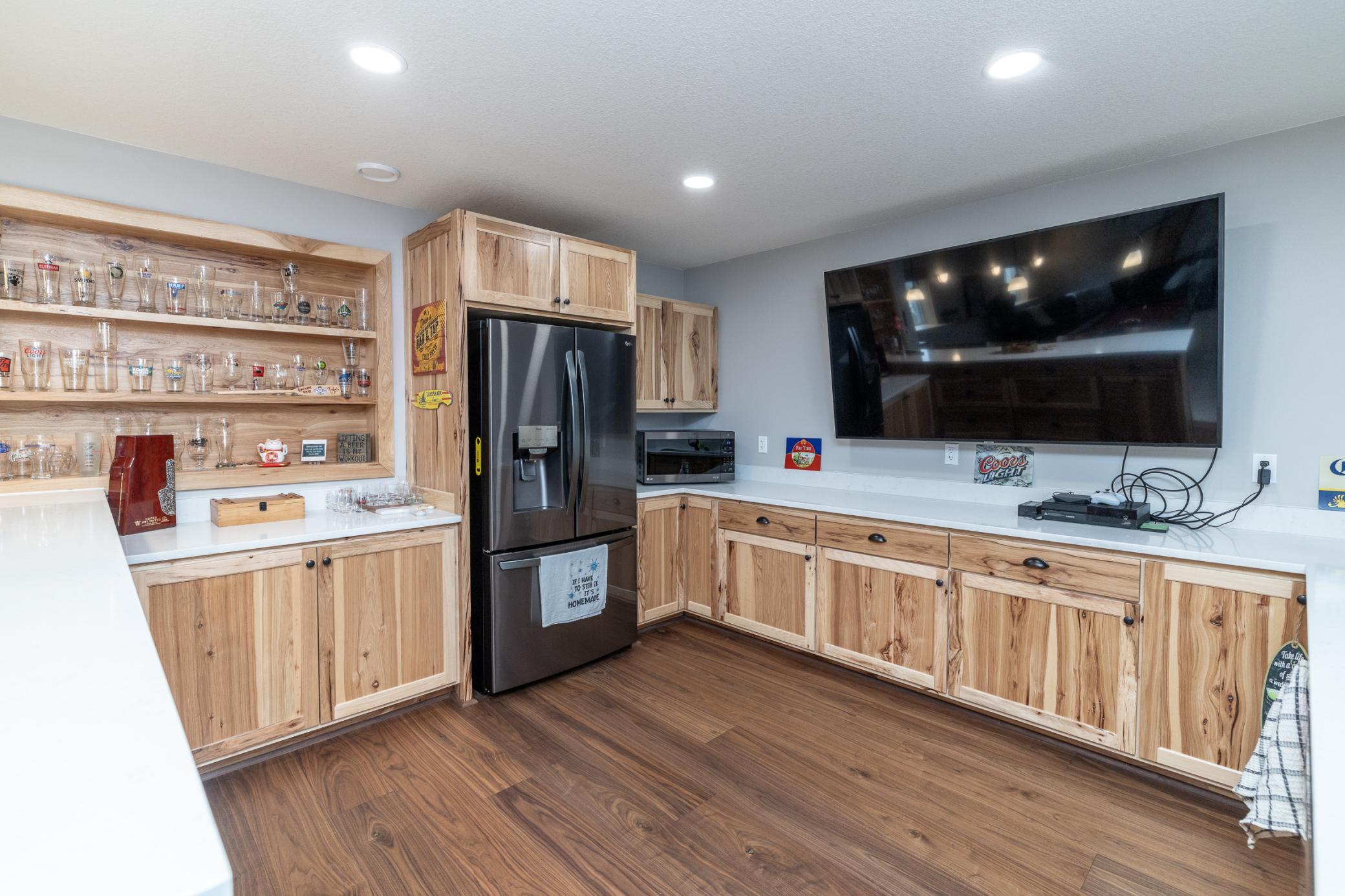 Stylish wet bar with ample storage and entertainment space