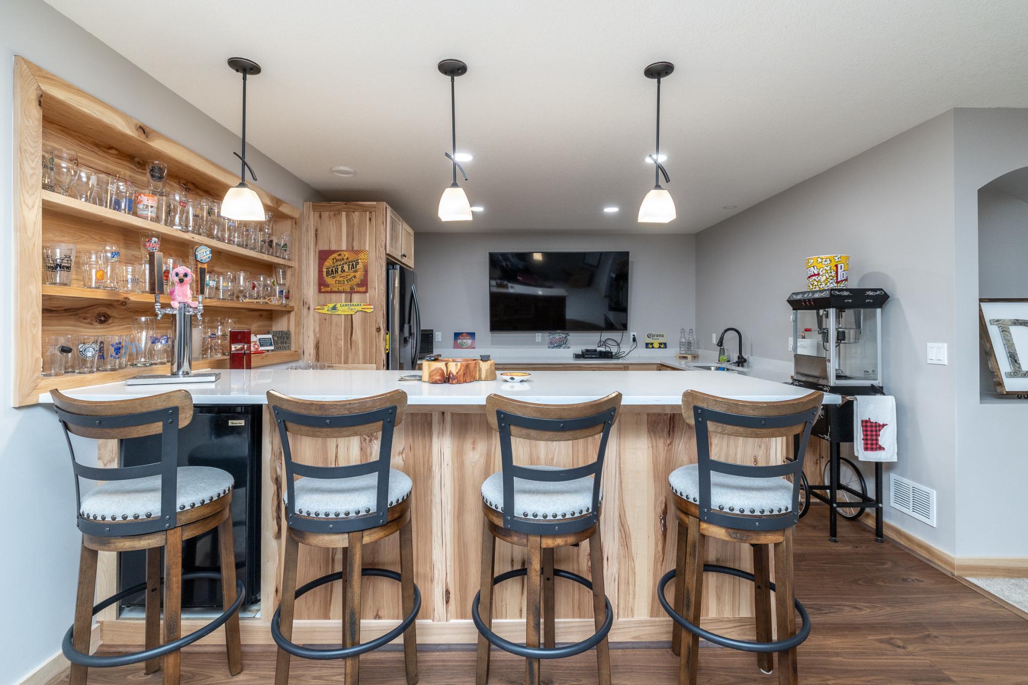 Expansive lower-level entertaining area with bar seating