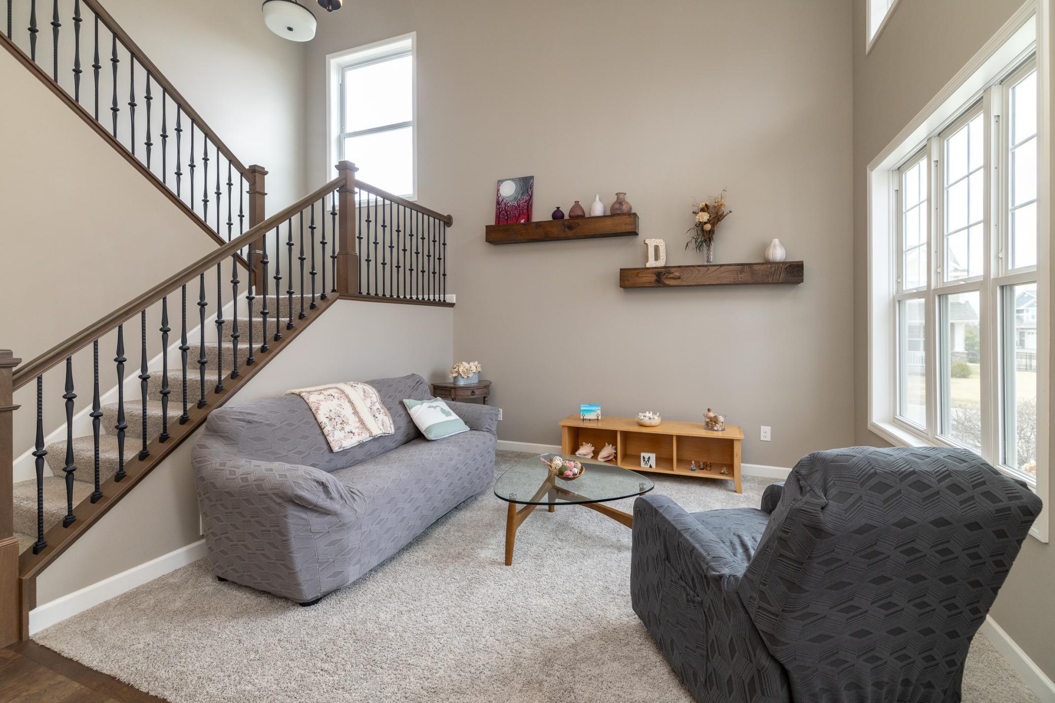 Bright and inviting main-level sitting area with soaring ceilings