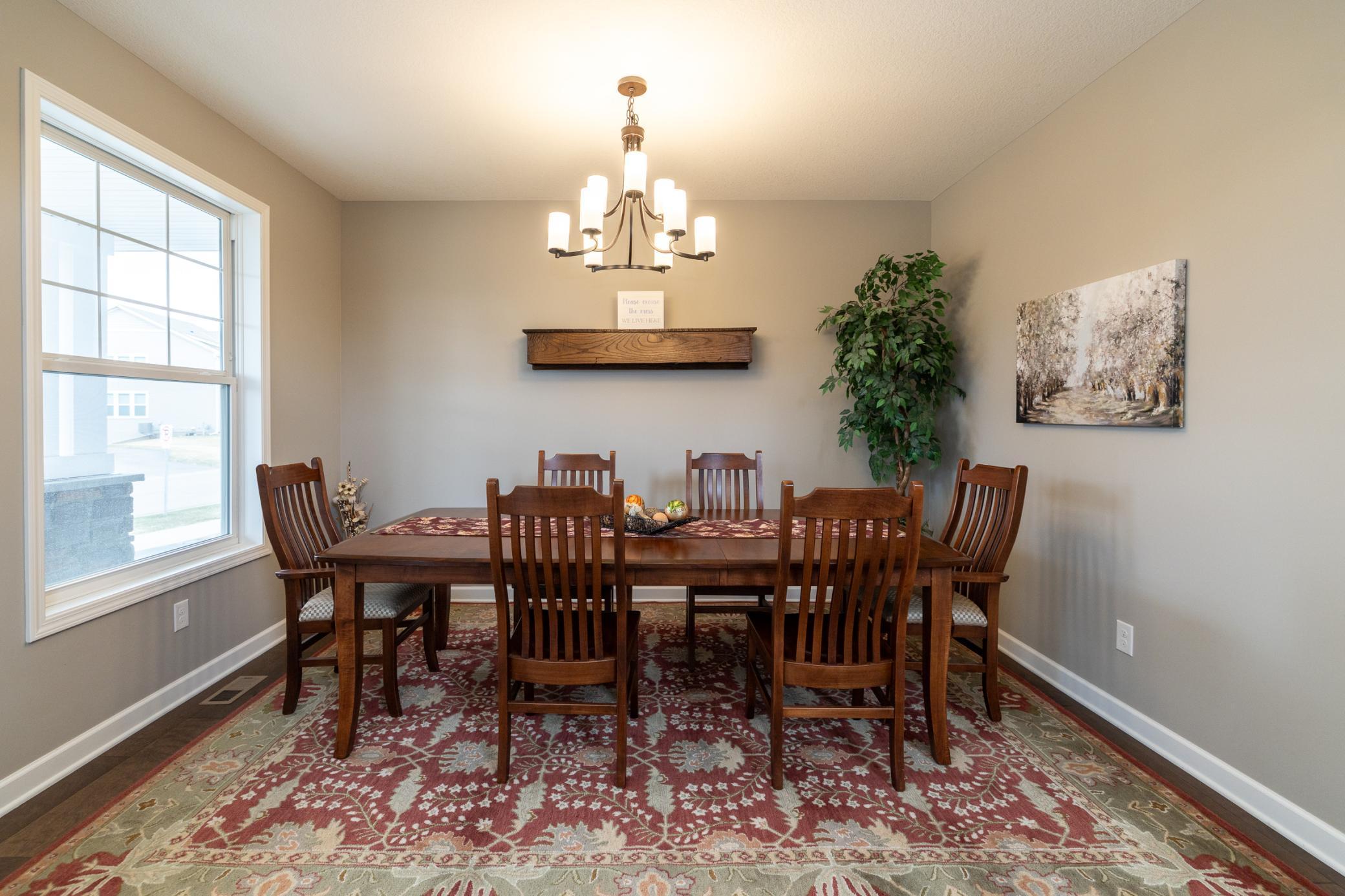 Bright and airy dining space with ample room for hosting, seamlessly positioned off the open foyer and dramatic two-story living room