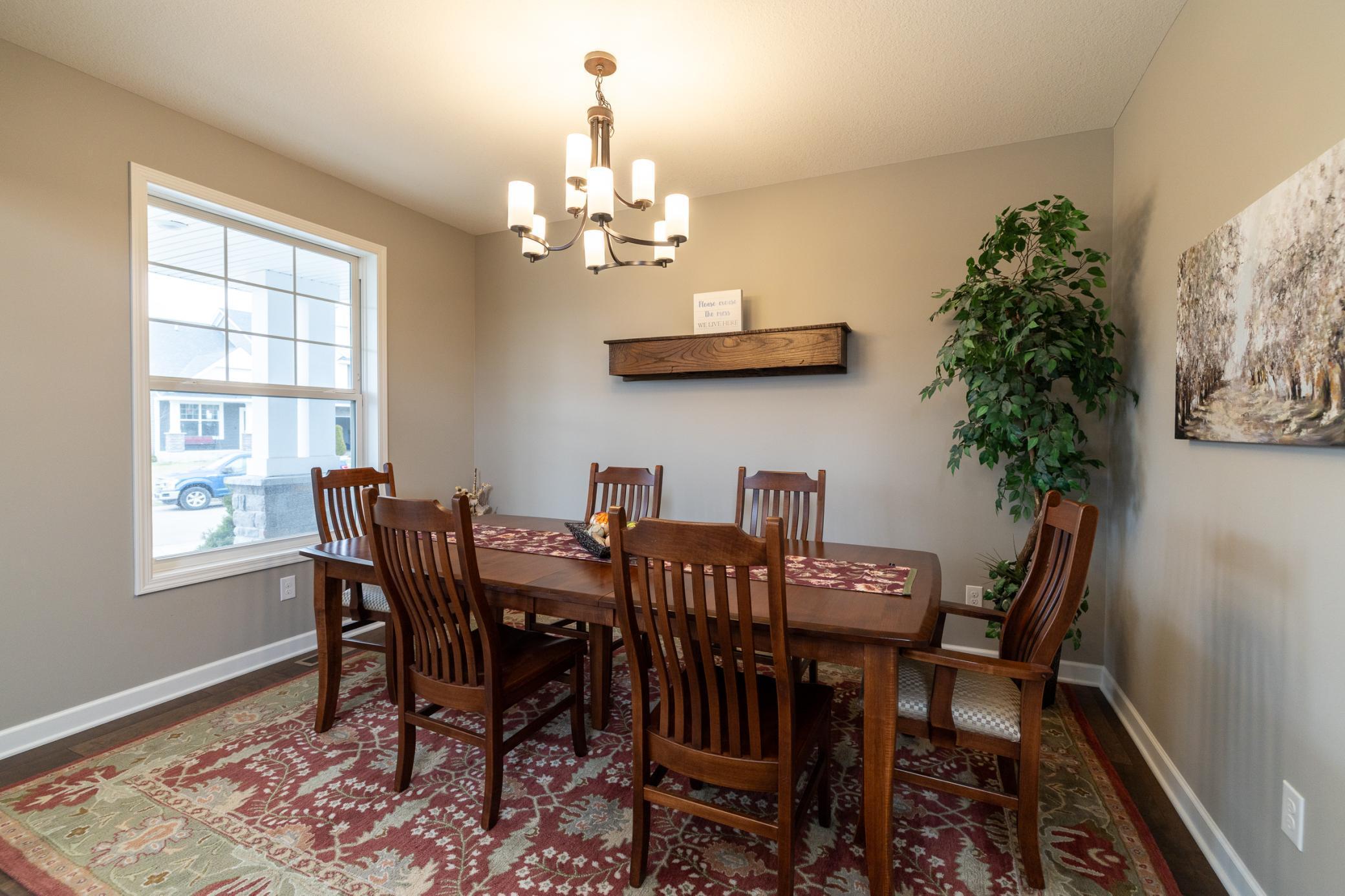 Bright and airy dining space with ample room for hosting, seamlessly positioned off the open foyer and dramatic two-story living room