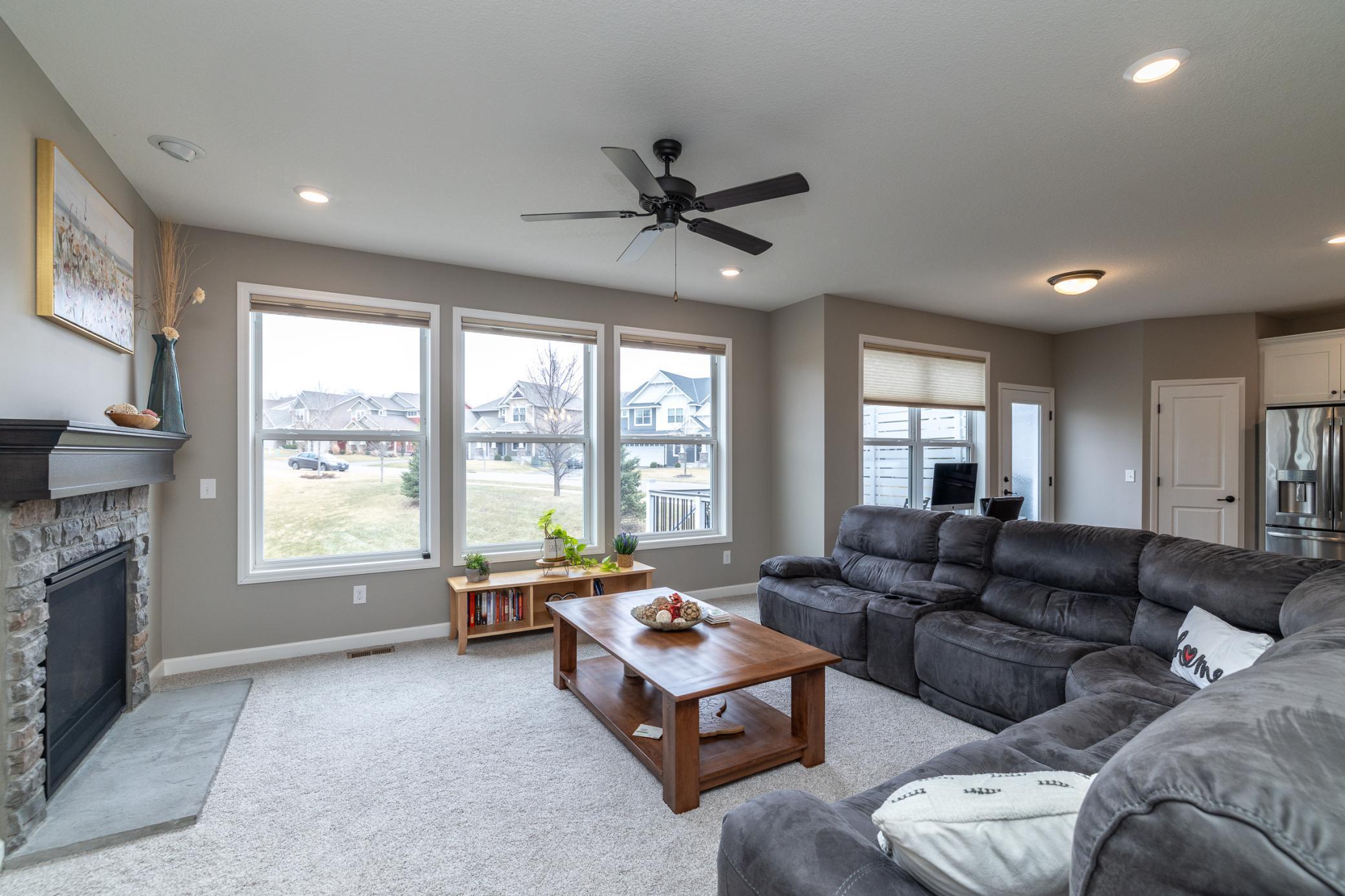 Bright family room with oversized windows and peaceful backyard views