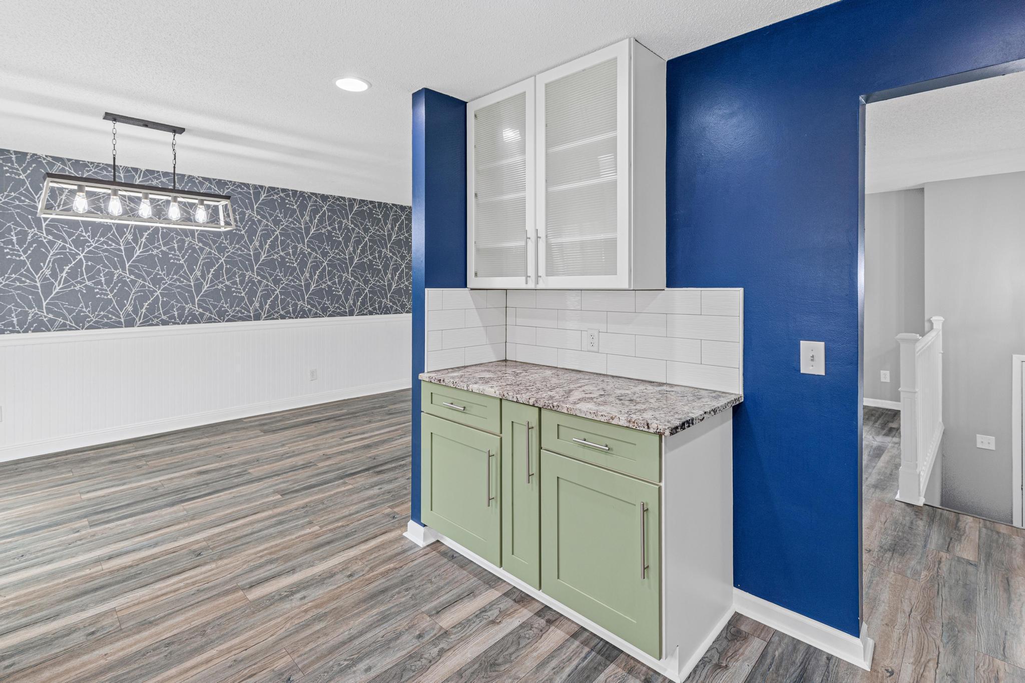 Accented buffet space with glass doors on the upper cabinets.