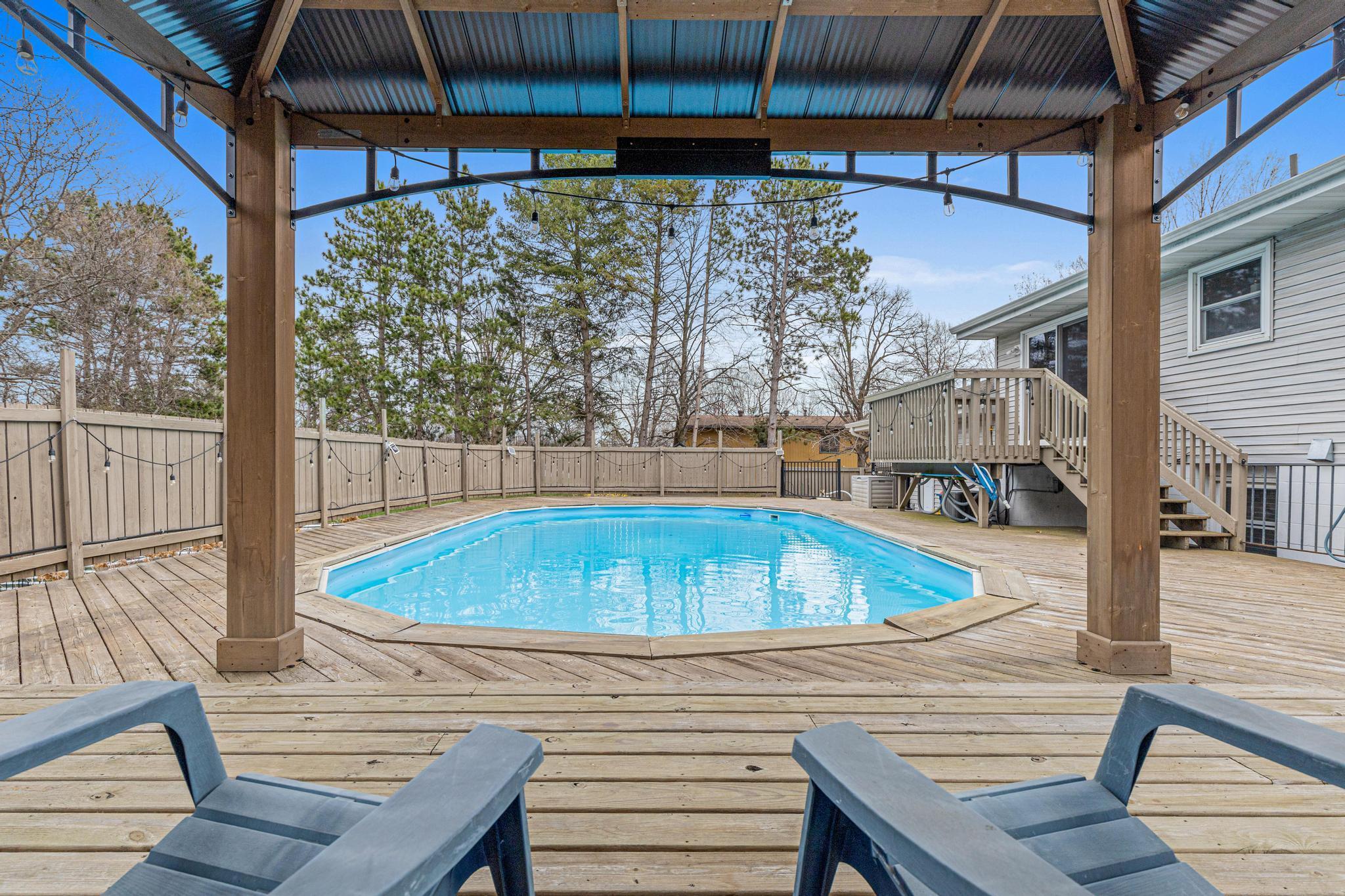 Above ground pool with a large deck all of the way around.