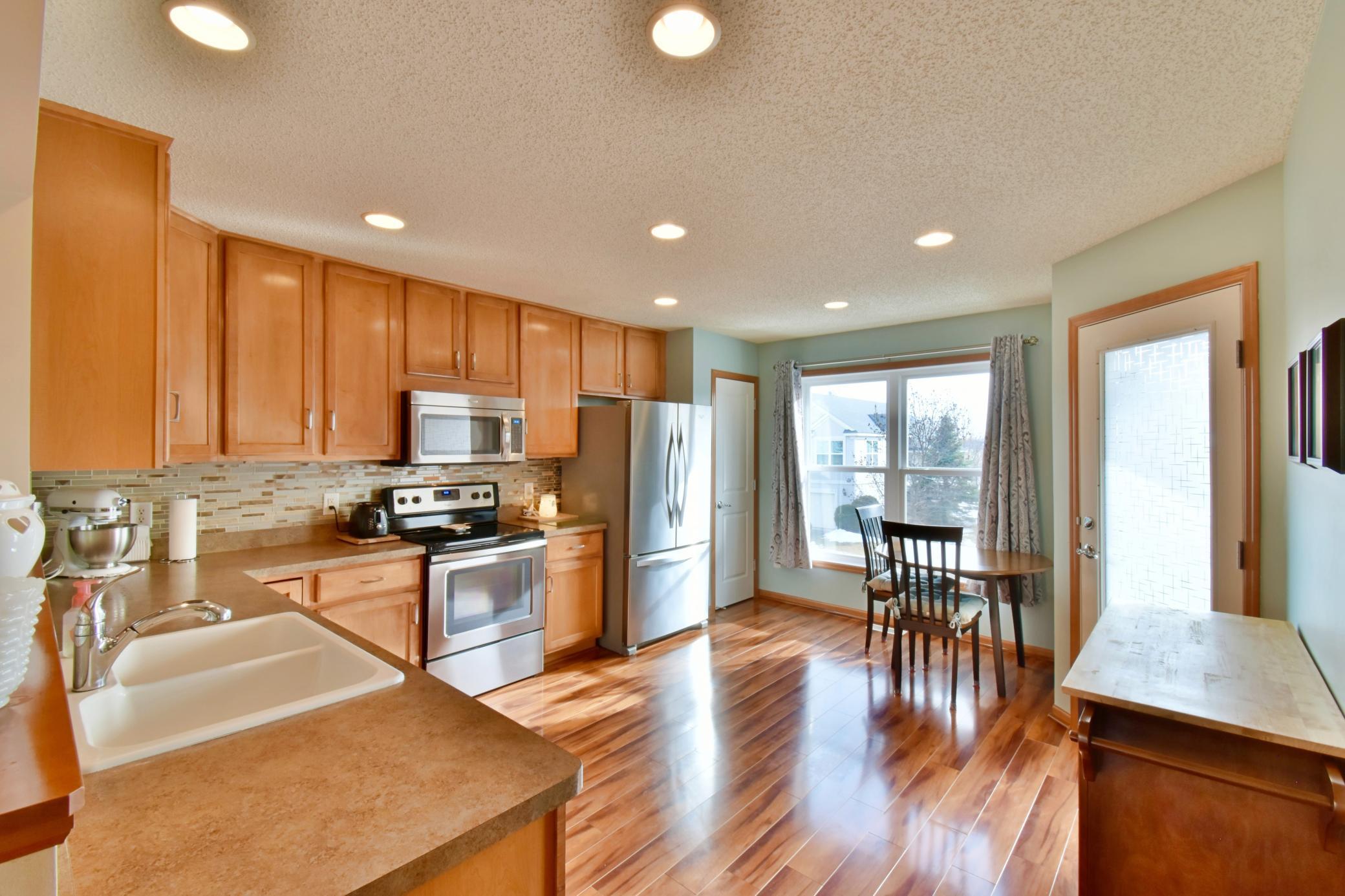 Large kitchen with plenty of counter space and cabinets and also space for a eat in area!