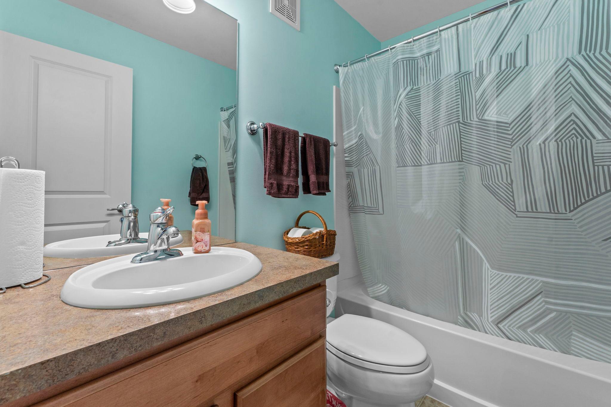 Upper level full bathroom has a calm, yet contemporary feel