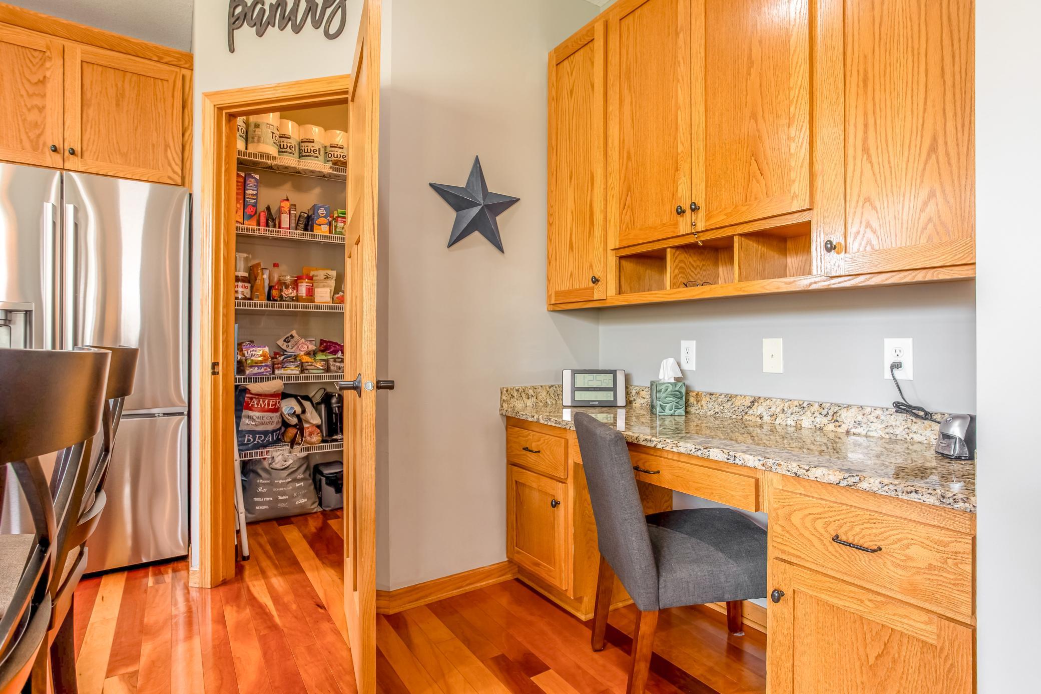 Convenient built-in workspace and walk-in pantry provide excellent functionality and storage just off the kitchen.
