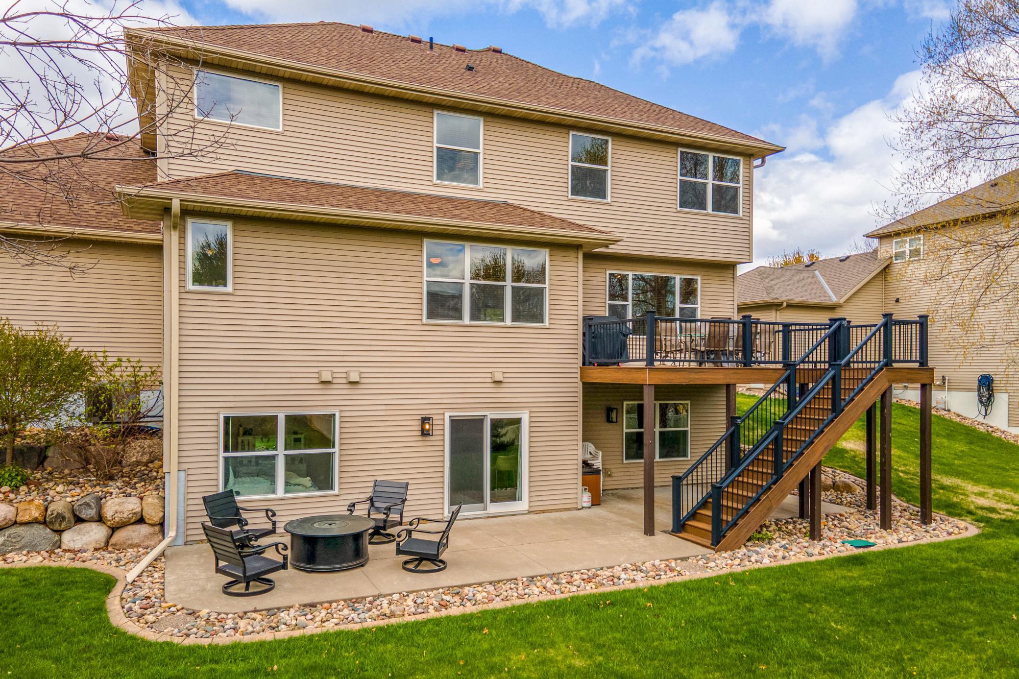 Spacious rear exterior showcasing multiple outdoor living areas, a walkout patio, and a private backyard perfect for entertaining.