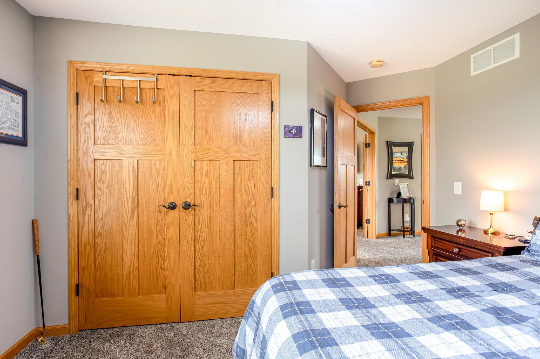 Comfortable secondary bedroom featuring warm finishes, ample closet space, and easy access to the upper-level living areas.
