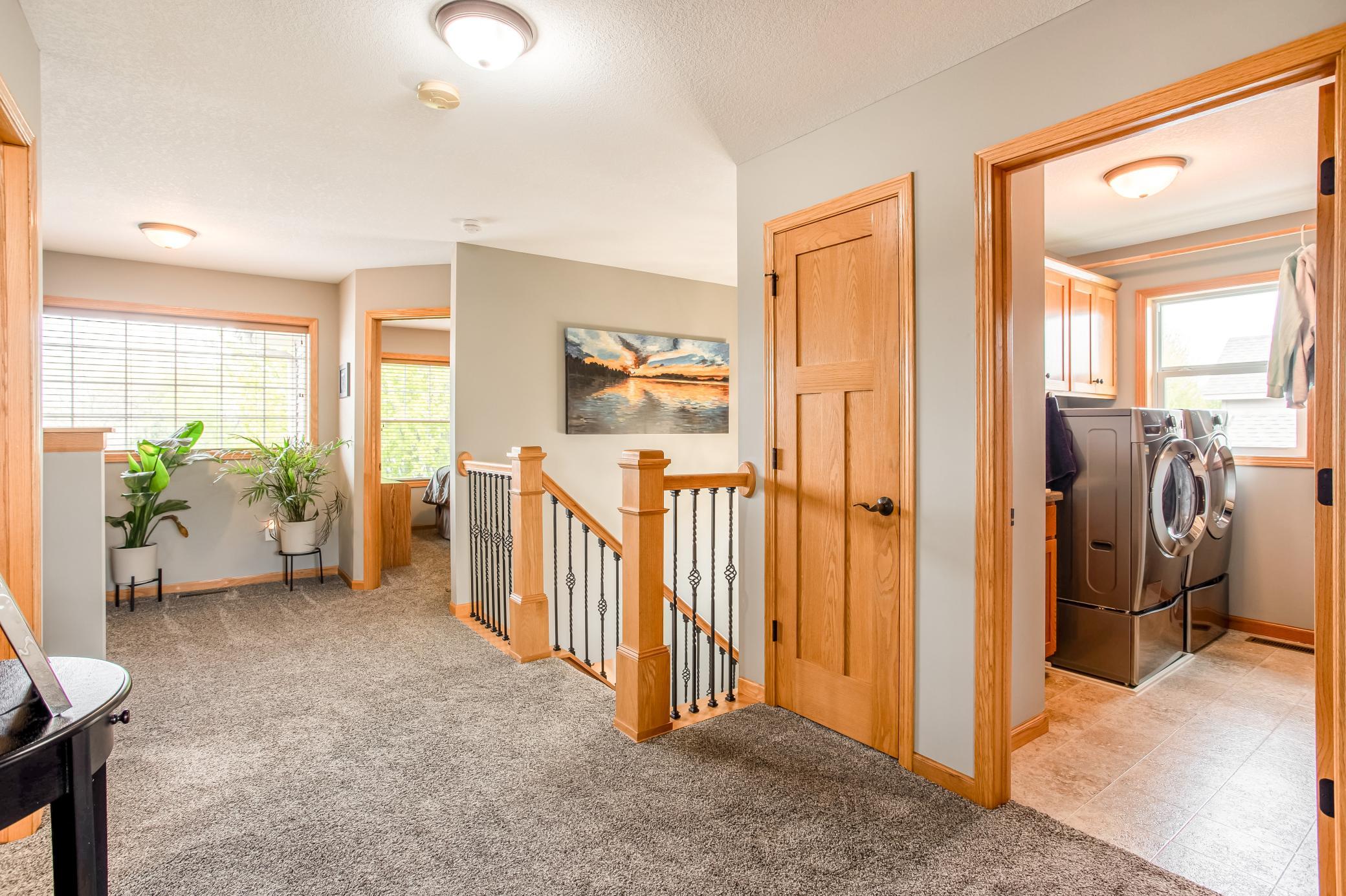 Spacious upper-level loft and hallway area with abundant natural light and flexible space for reading, work, or relaxation.