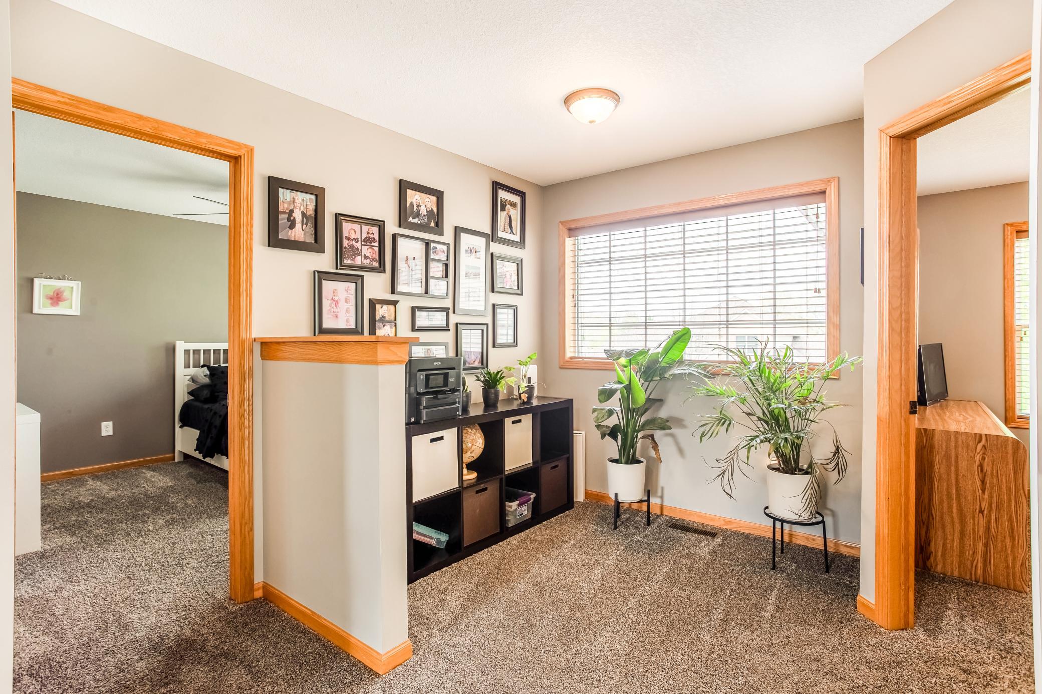 Cozy upper-level loft with natural light and the perfect space for organization or a quiet retreat.