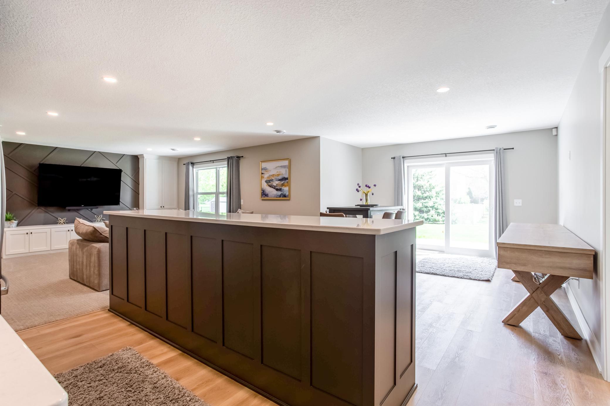 Spacious lower level designed for entertaining with expansive counter seating, durable flooring, and open-concept functionality.
