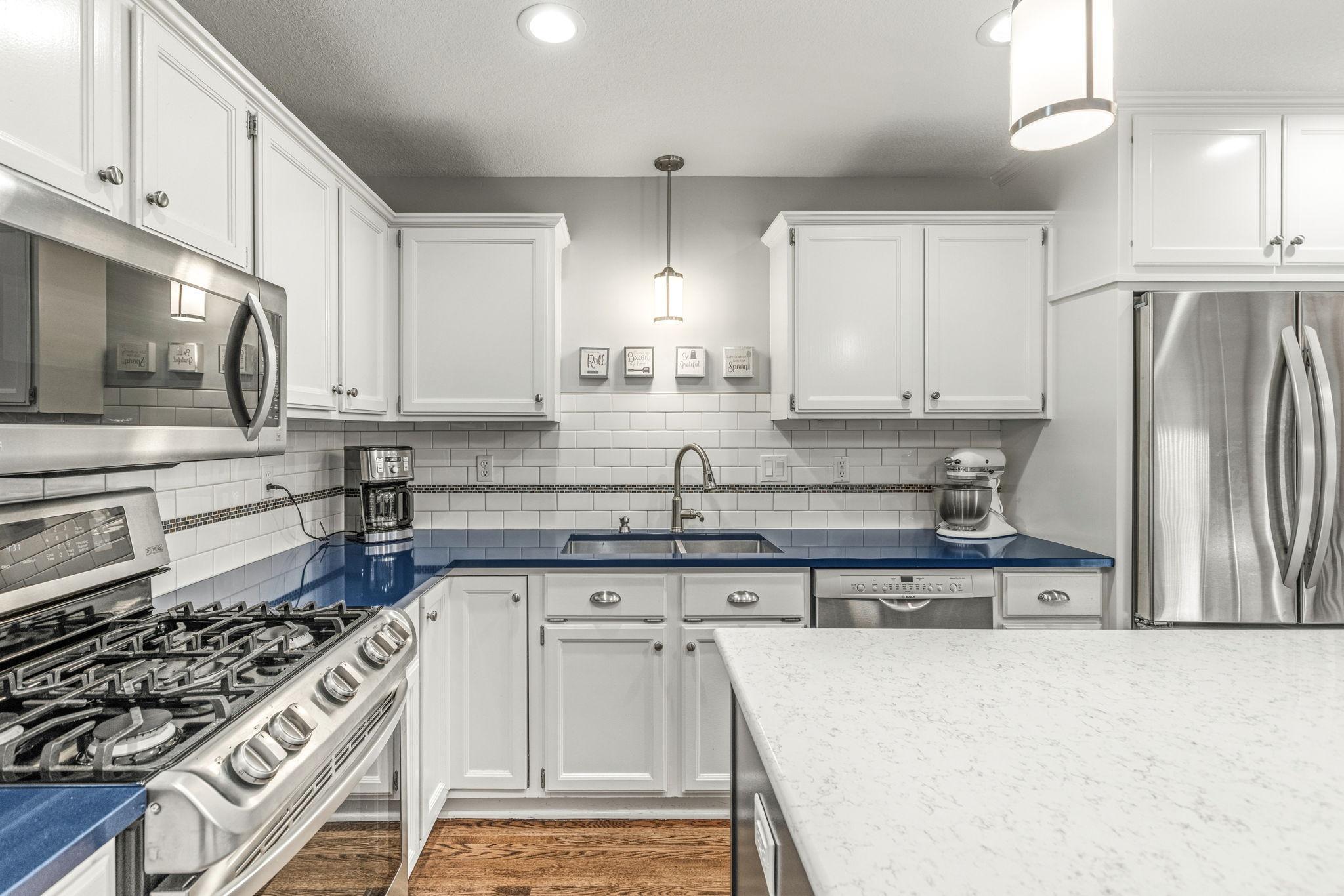 Beautifully updated kitchen with subway tile backsplash, granite island and stainless steel appliances!