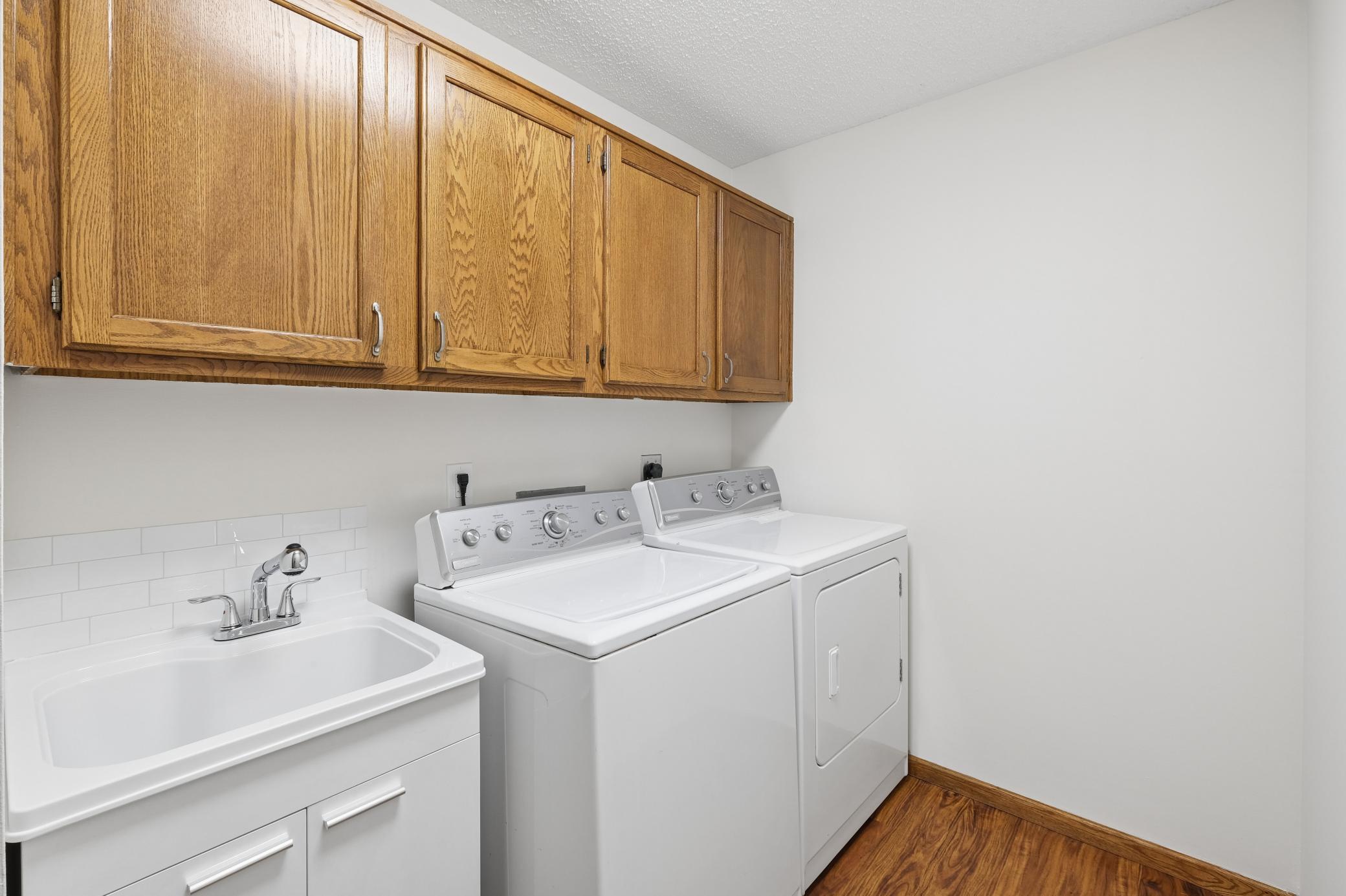 The convenient laundry room is located off the garage and has a new laundry sink