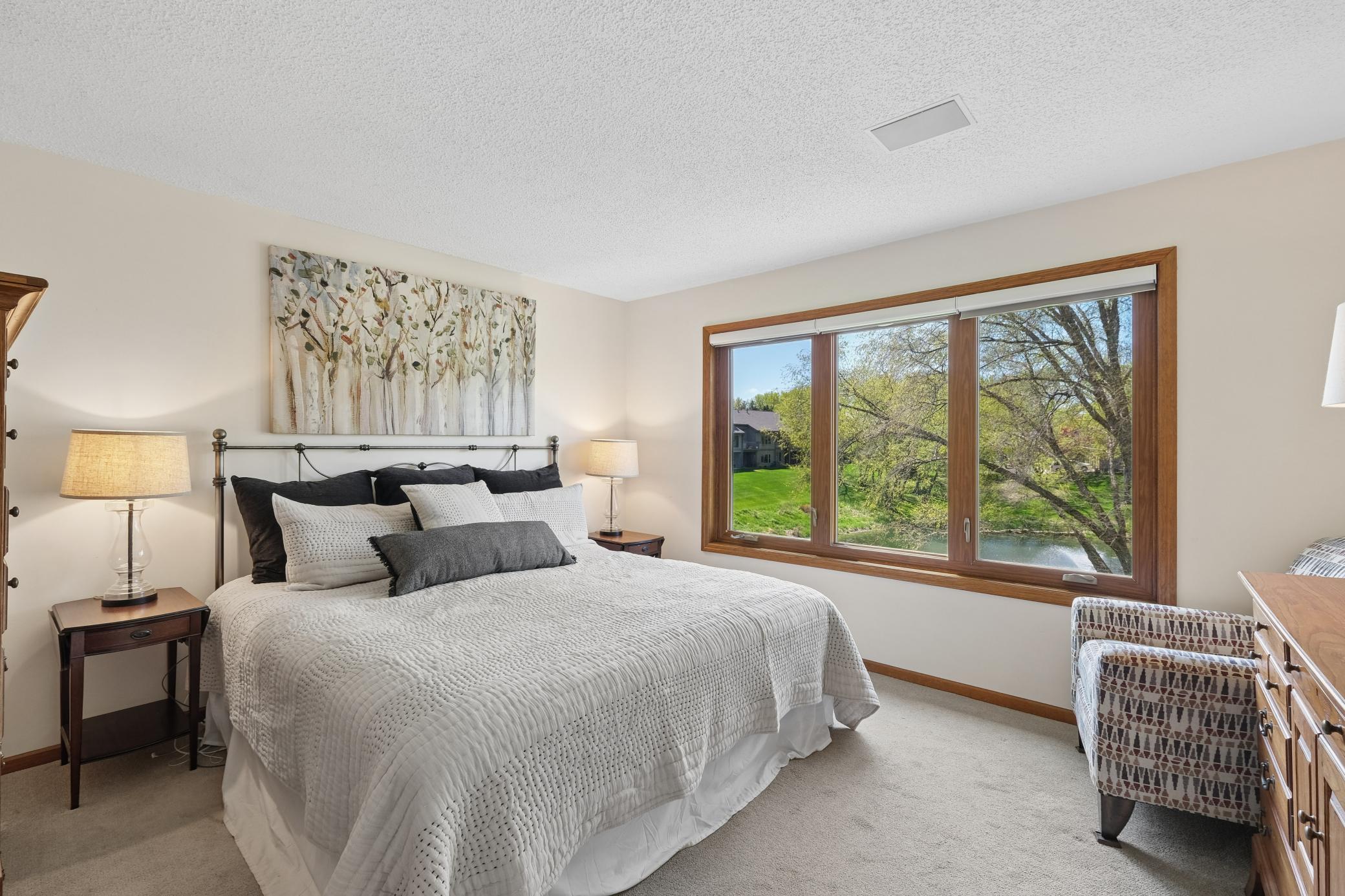 The main level primary suite has beautiful views to wake up to.