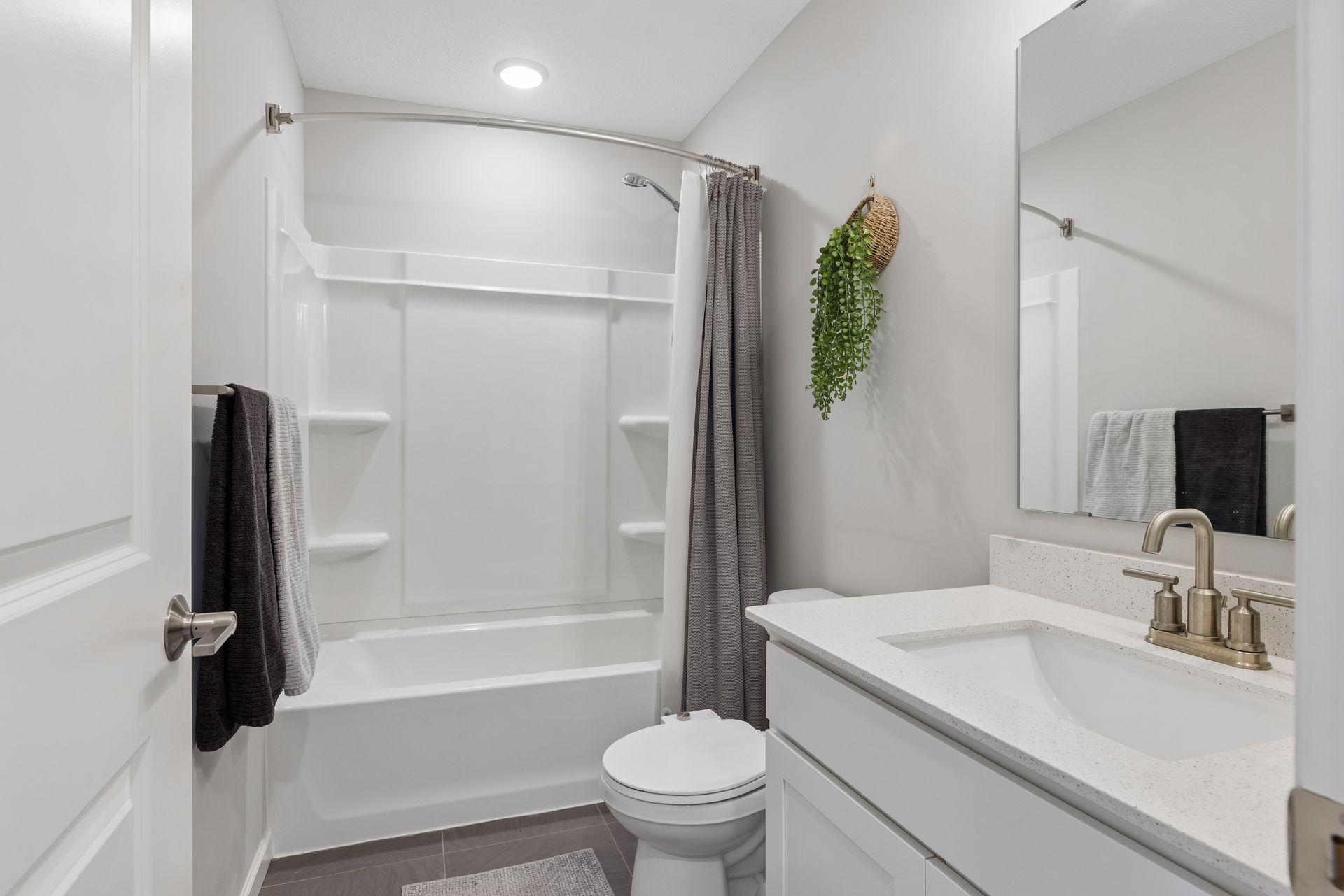 Upper-level full bathroom with tub and shower combination.